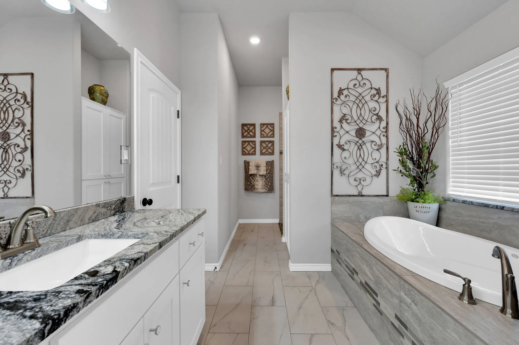 Luxurious primary bath with a vanity and a relaxing soaking tub.