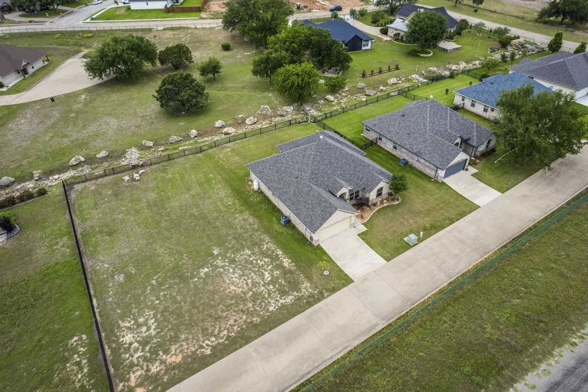 Aerial view of the home showing the spacious lot and surrounding green space.