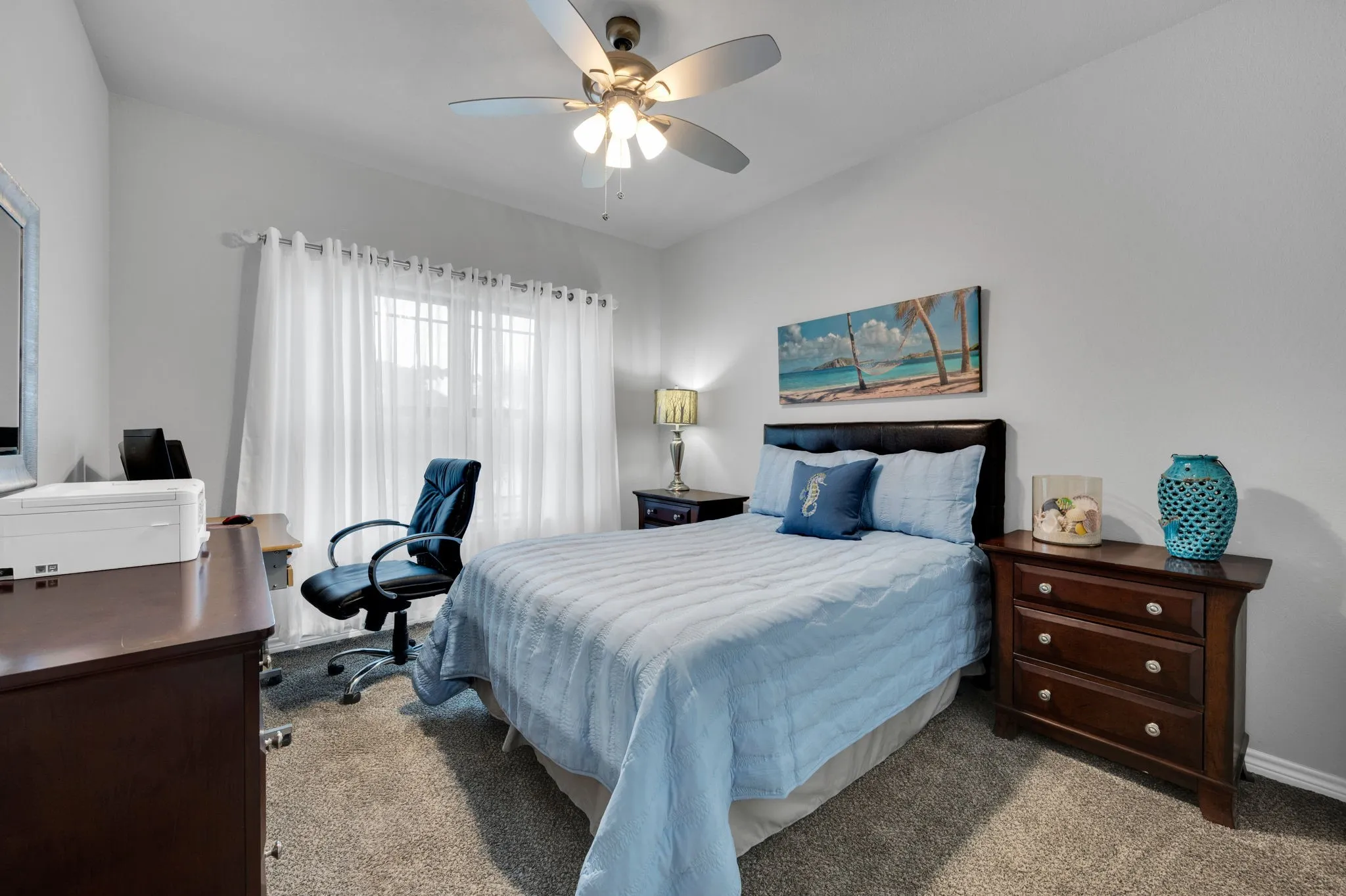 Second bedroom with warm flooring and a bright window.