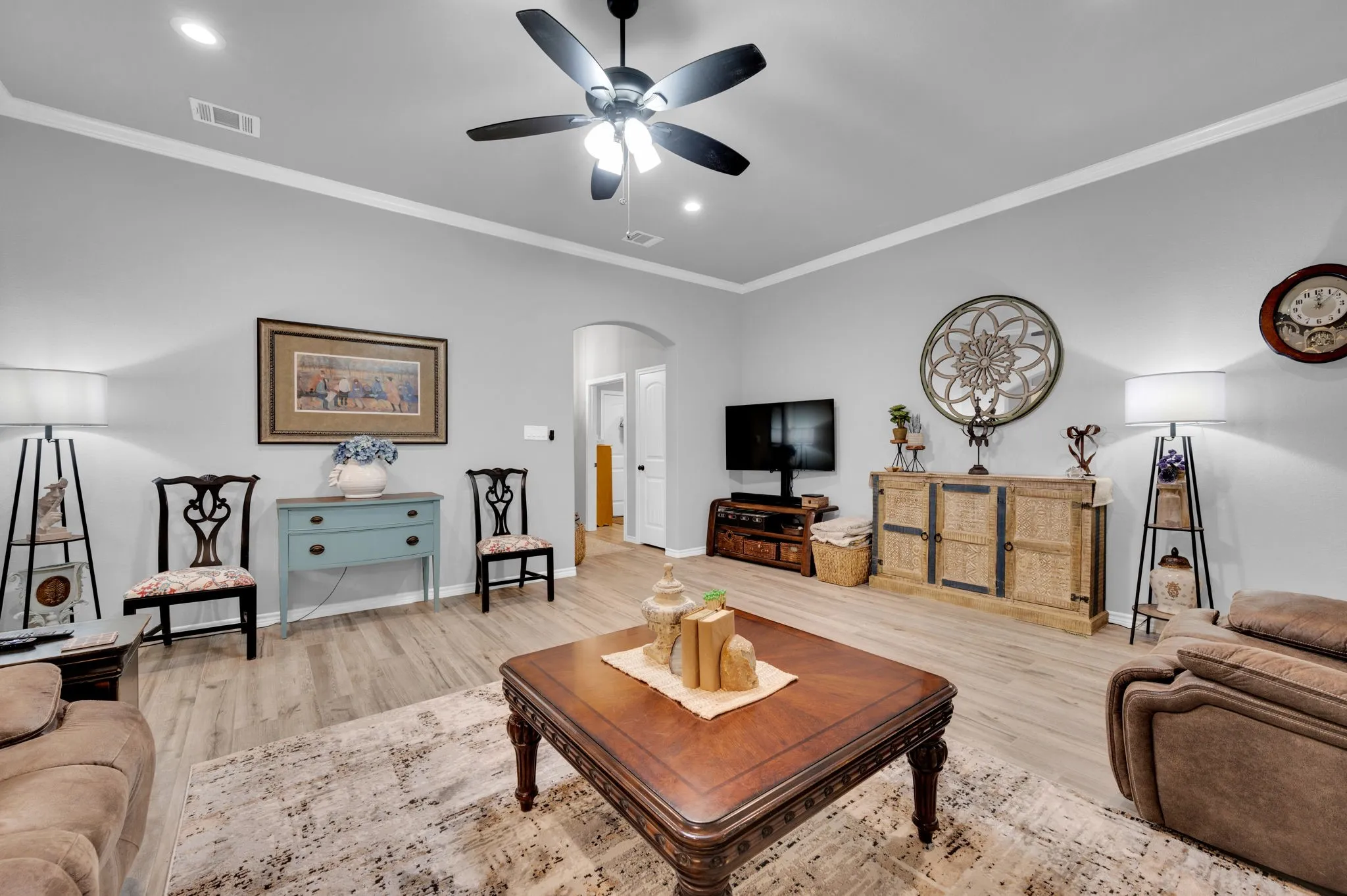 Open living room with crown molding and a flowing floor plan, ideal for gathering with family and friends.