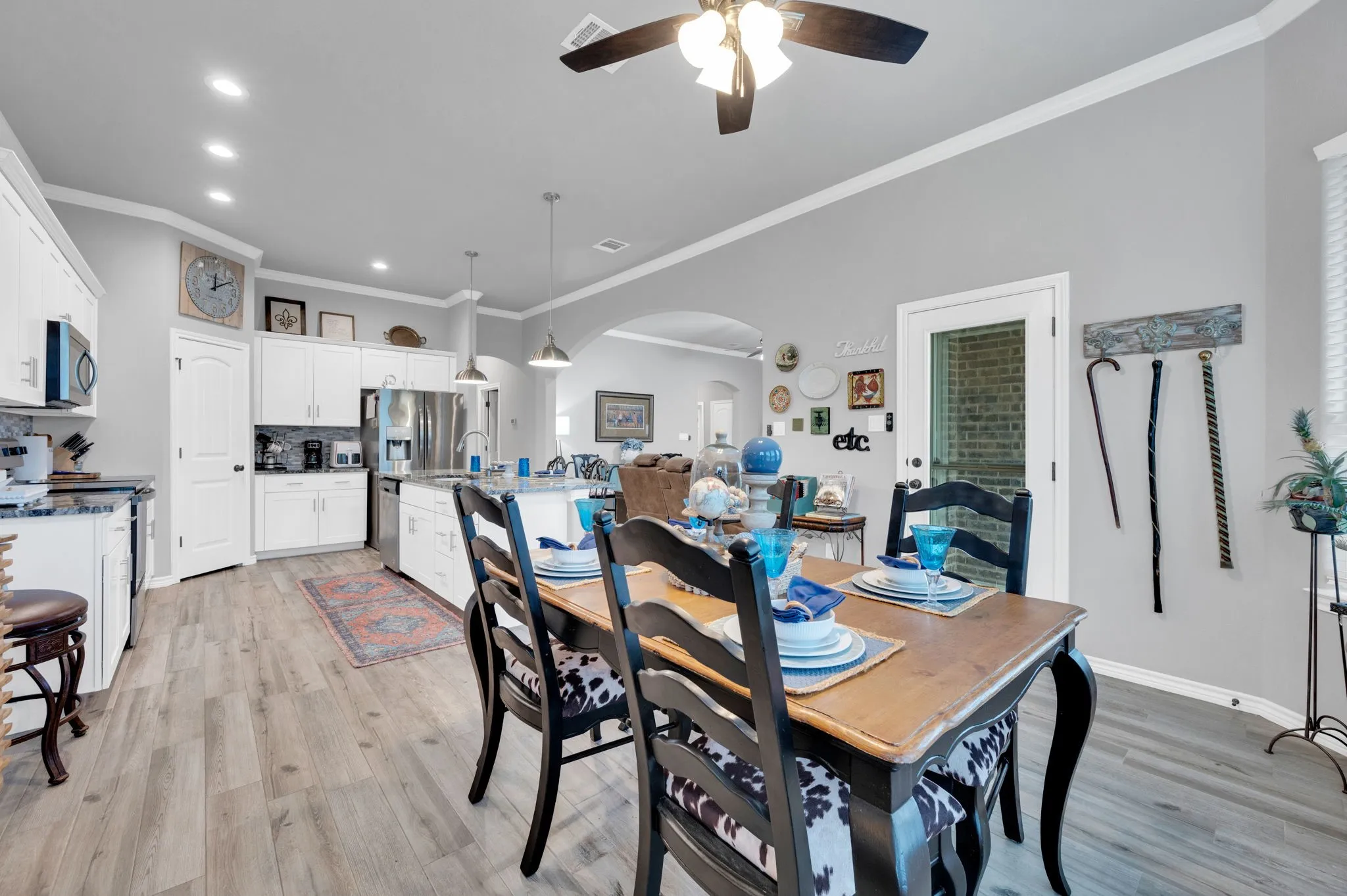 Dining area with built-in cabinetry and warm flooring.