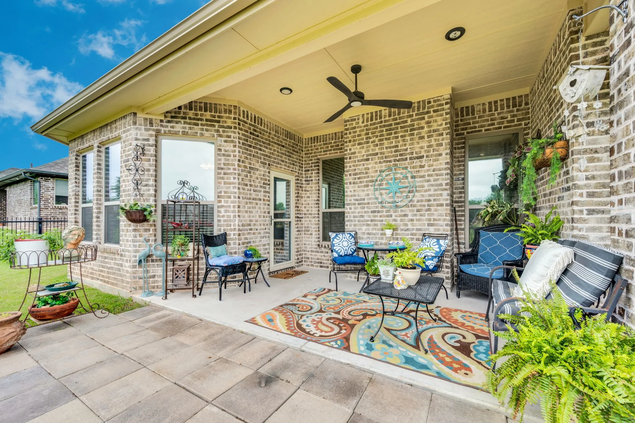 Covered patio offering plenty of shaded space to unwind, right off the main living area.