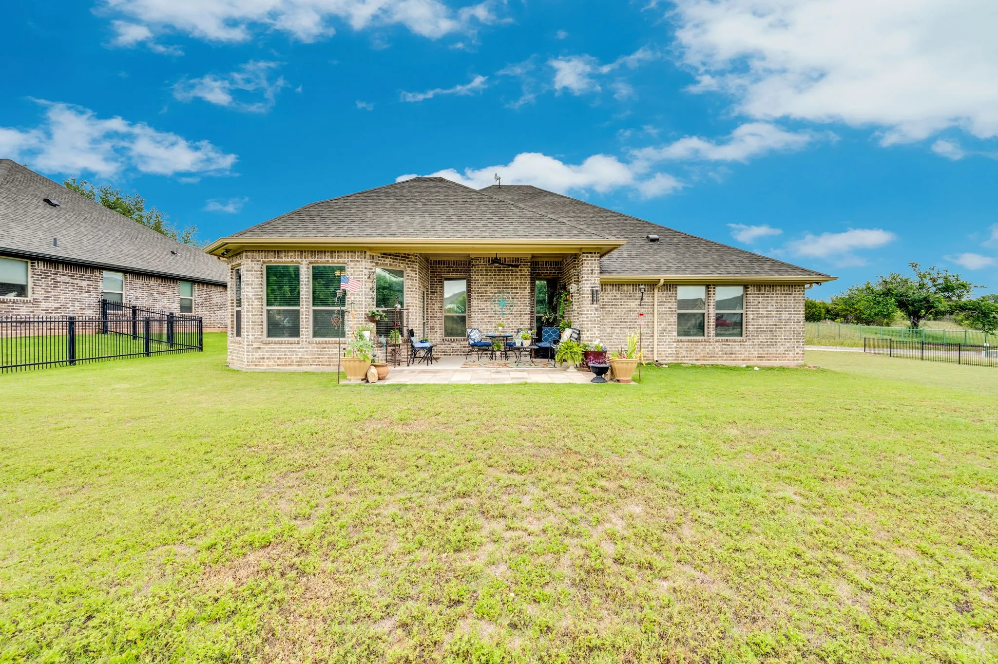 Rear exterior featuring a covered patio and a wide open backyard, ready for outdoor enjoyment.