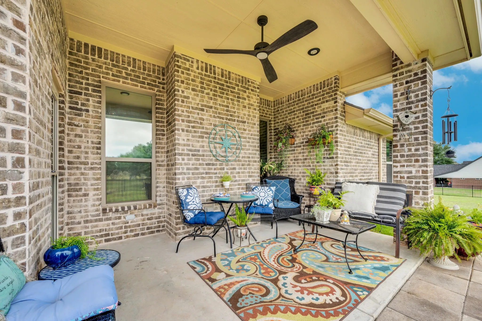 Covered back patio with brick columns, a perfect spot to relax and enjoy the outdoors.