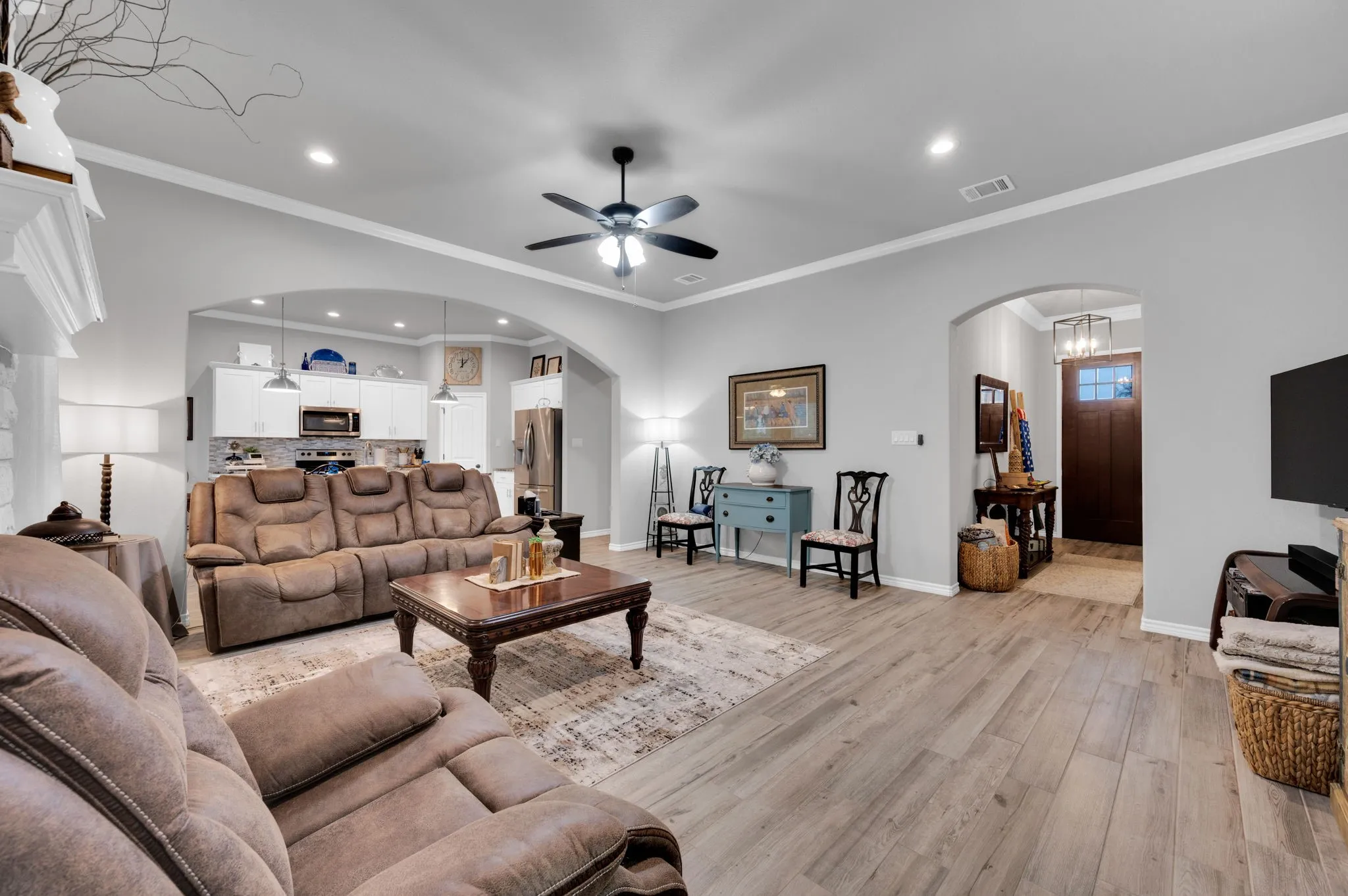 Spacious living area with elegant archway details and an easy flow into the rest of the home.