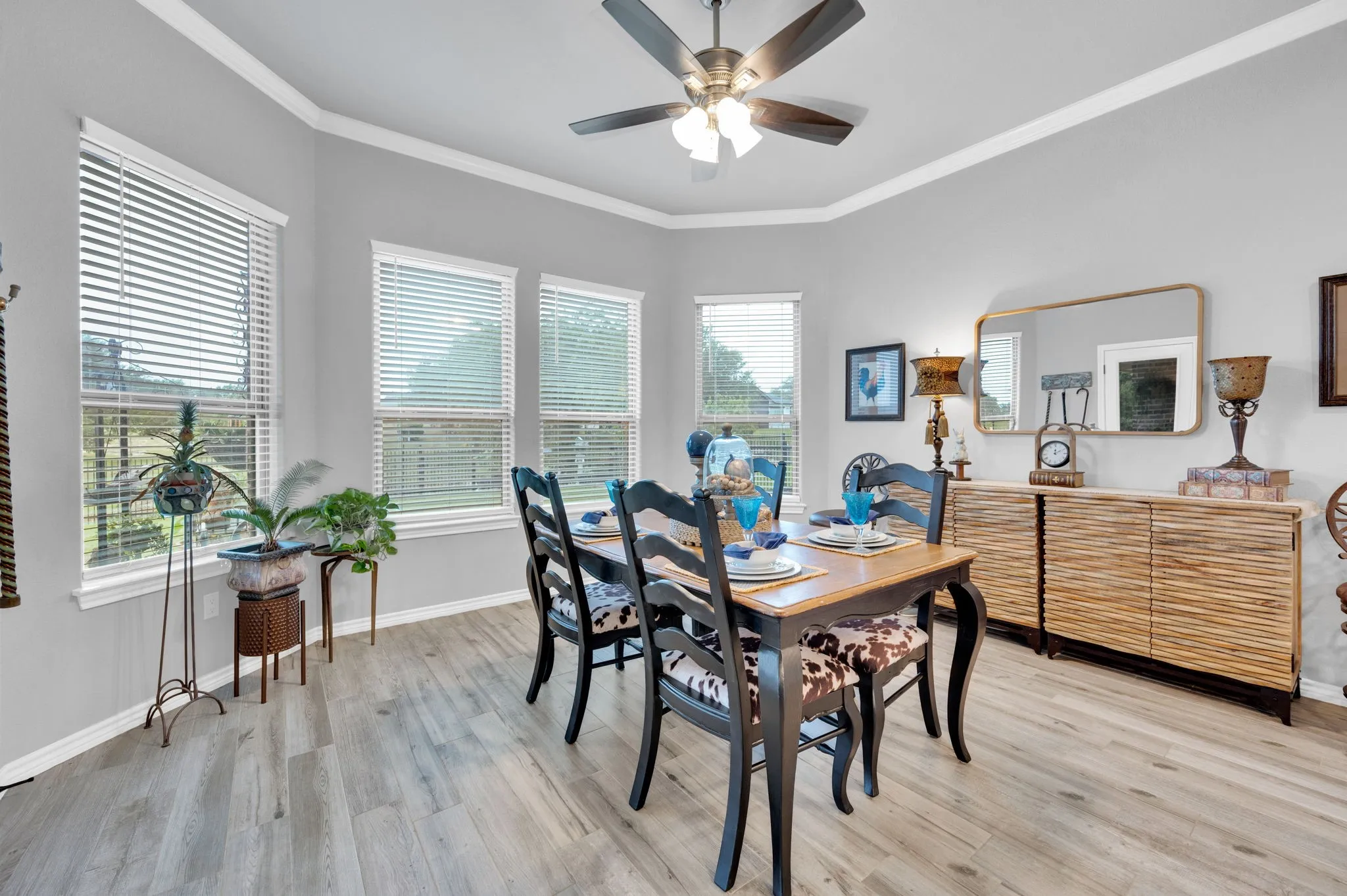 Sunlit dining room with oversized windows, a beautiful space to host meals with family and friends.