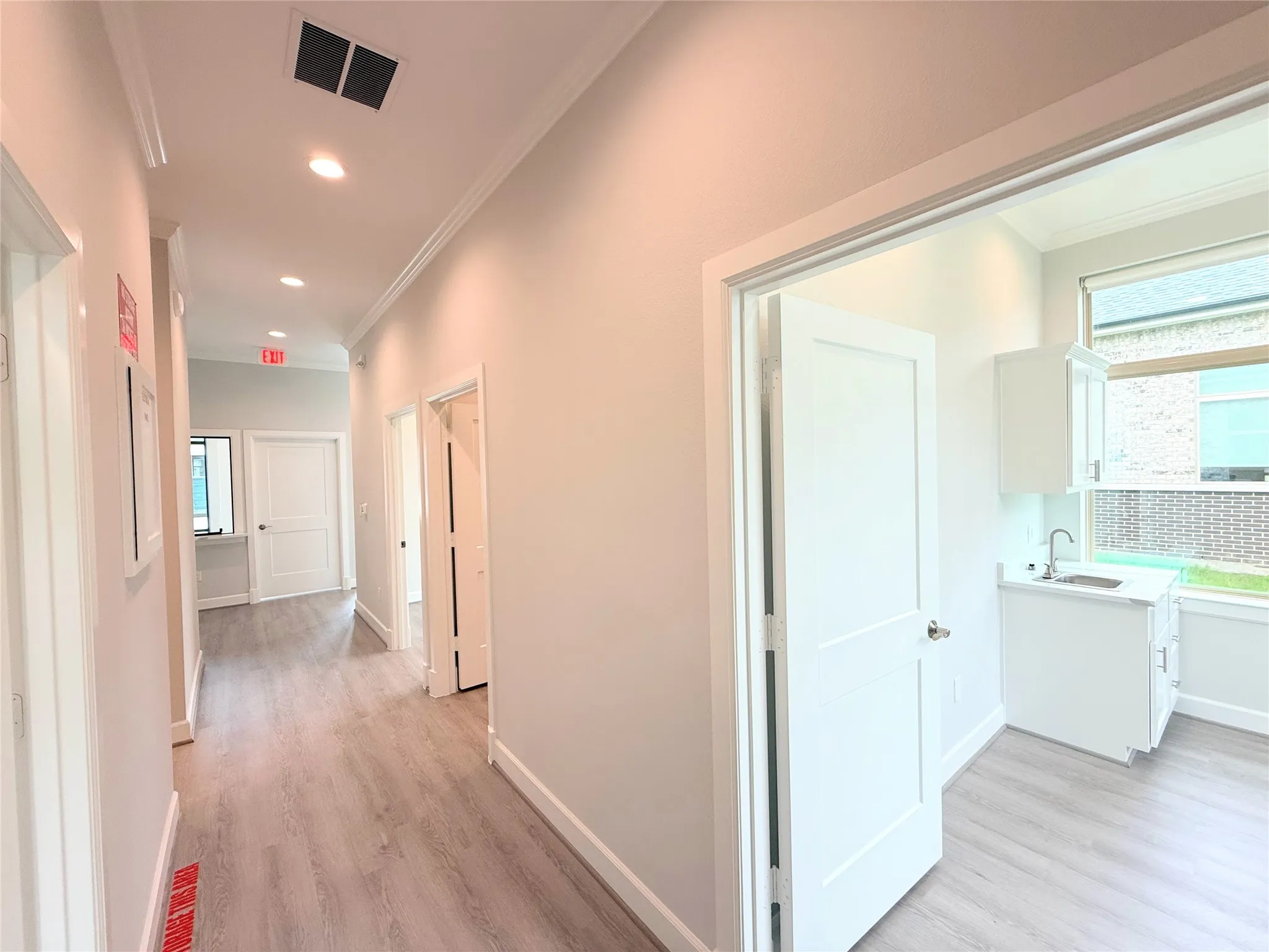 Hallway featuring wood-finish flooring and recessed lighting