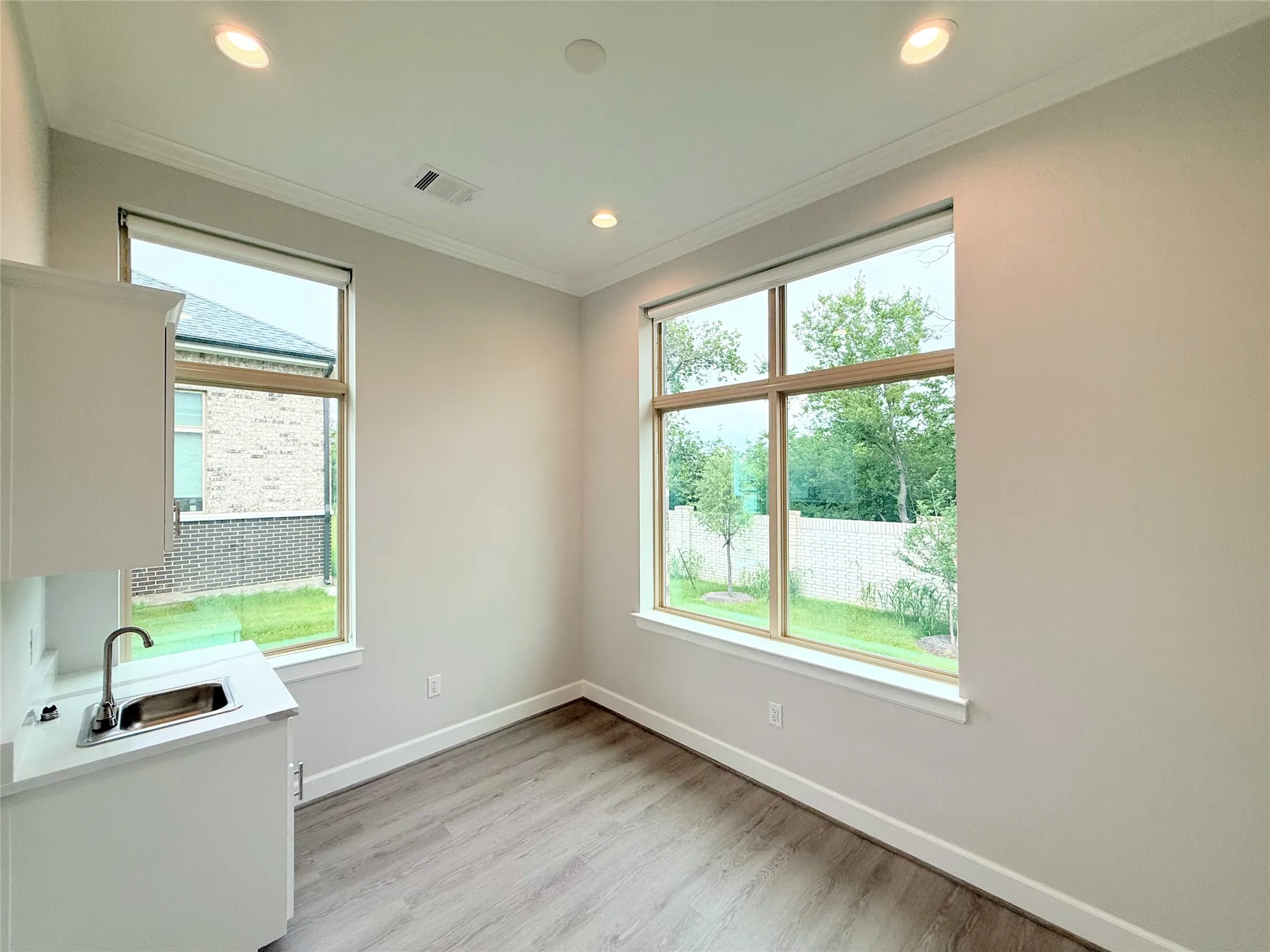 Room featuring wood-finish flooring and recessed lighting