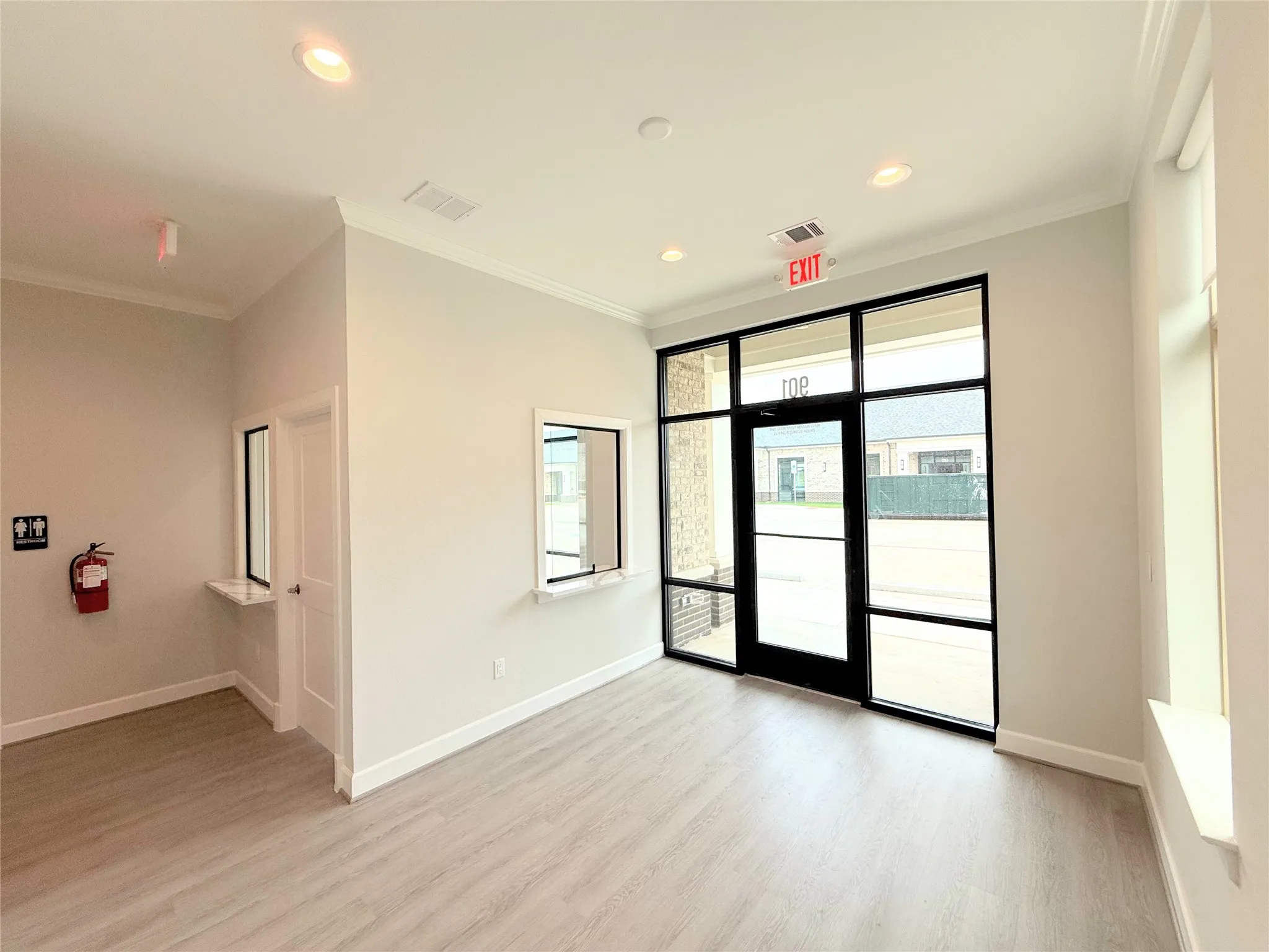 Light wood-finish flooring with crisp white baseboards