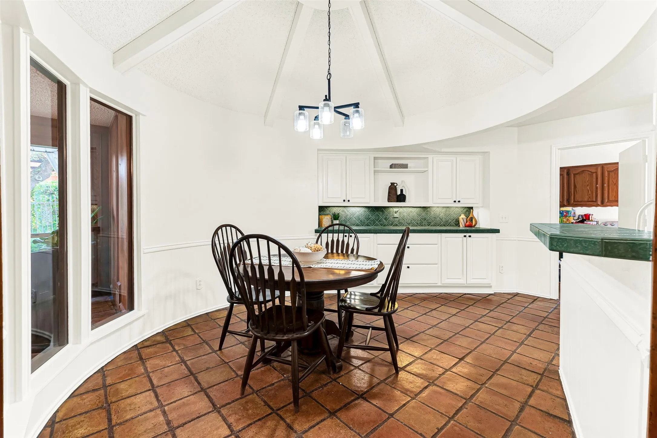 Breakfast area with tall ceiling makes this space feel even larger along with built ins for extra storage for entertaining, craft supplies...