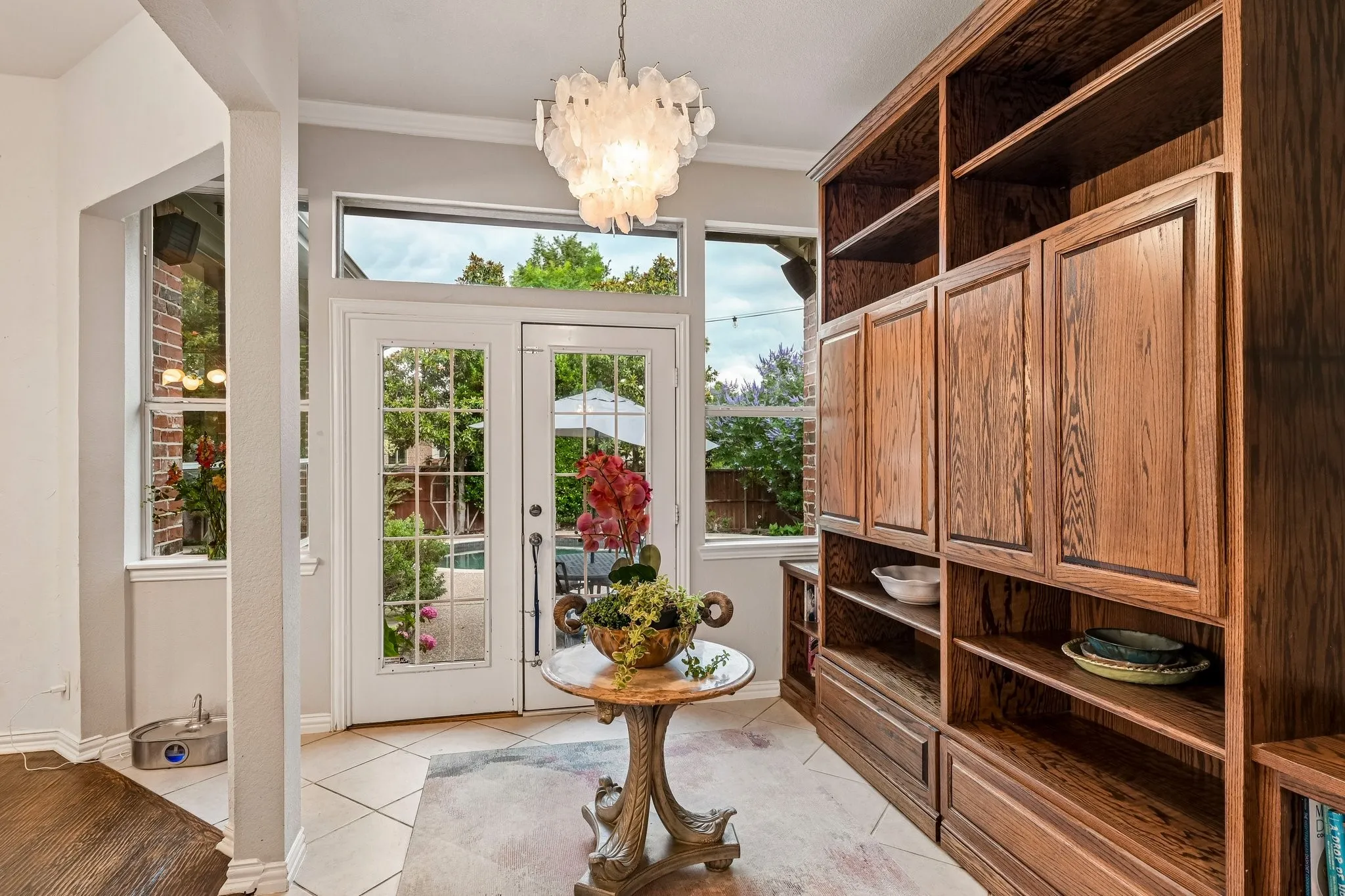 Built-in wood cabinetry and shelving complement the tiled flooring