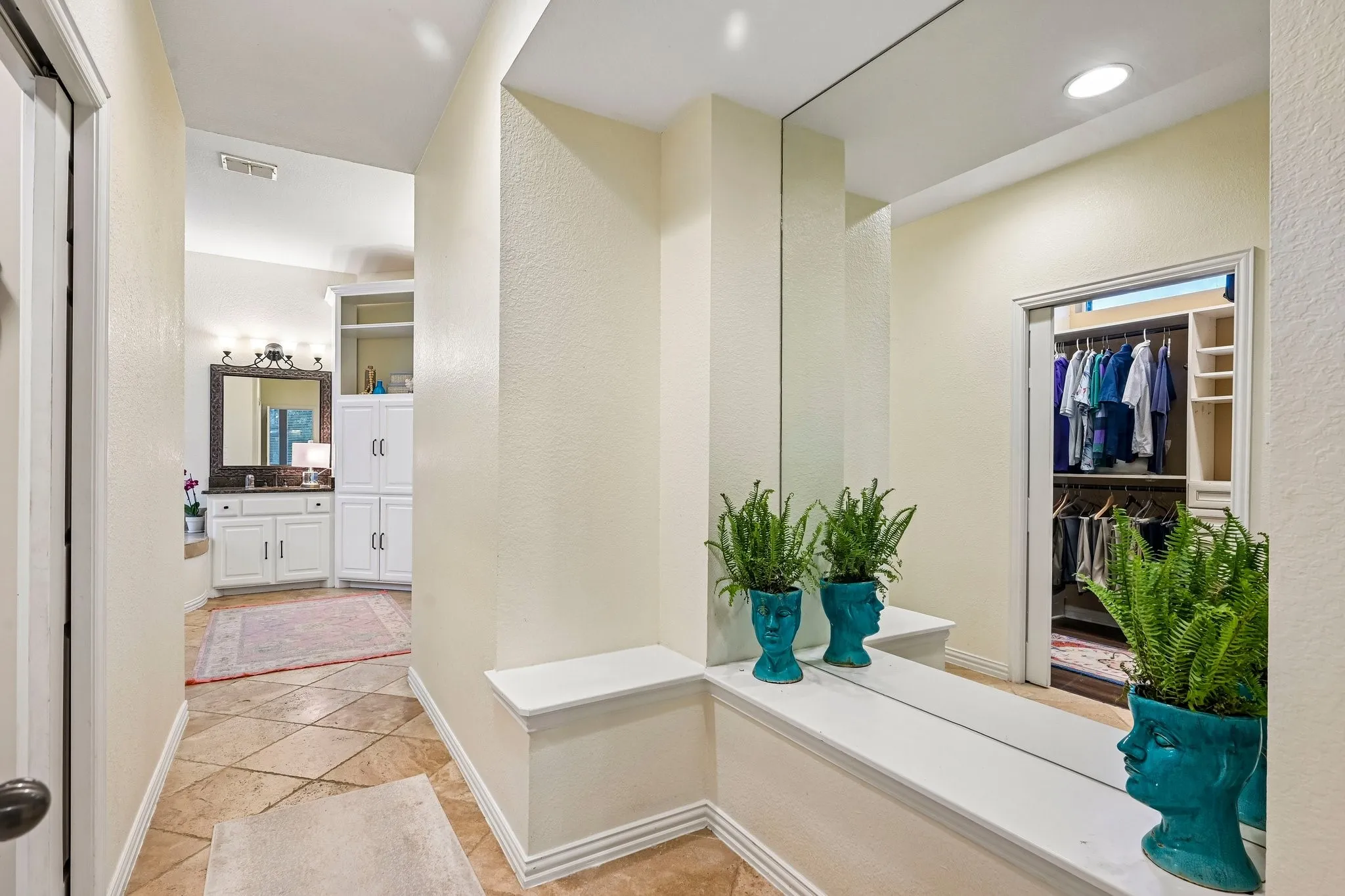 Hallway featuring full-height wall mirror, built-in shelving, recessed lighting, and tile flooring