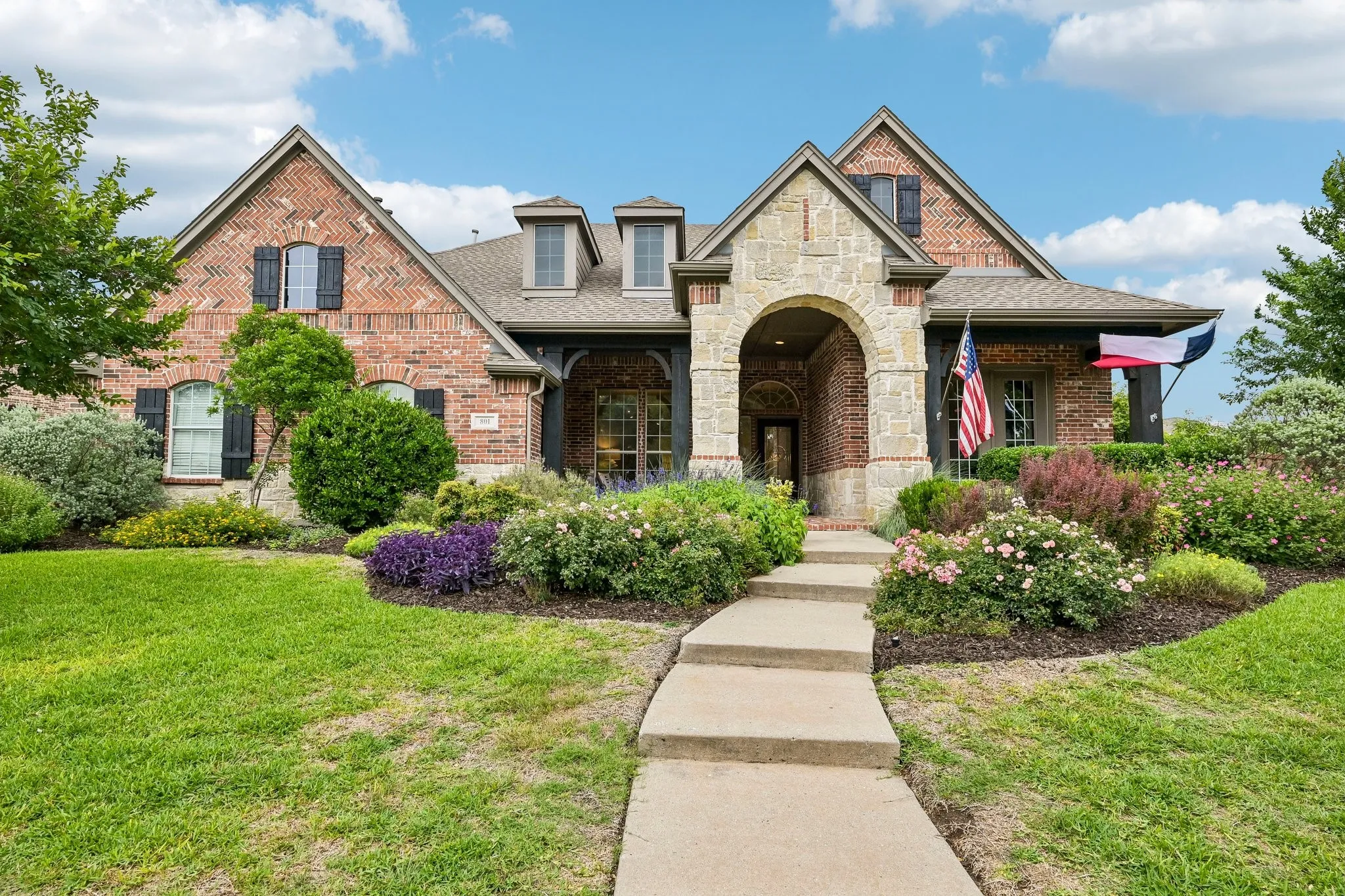 Traditional brick facade with stone accents and multiple gables