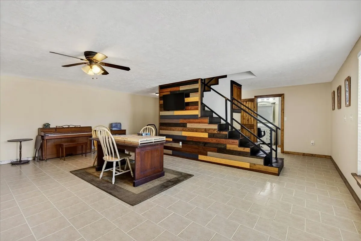 Basement 1565SF Expansive room featuring light-colored square tile flooring.  This space as so much potentials - family room, media room, game room, office space, and more.  French doors lead outside.