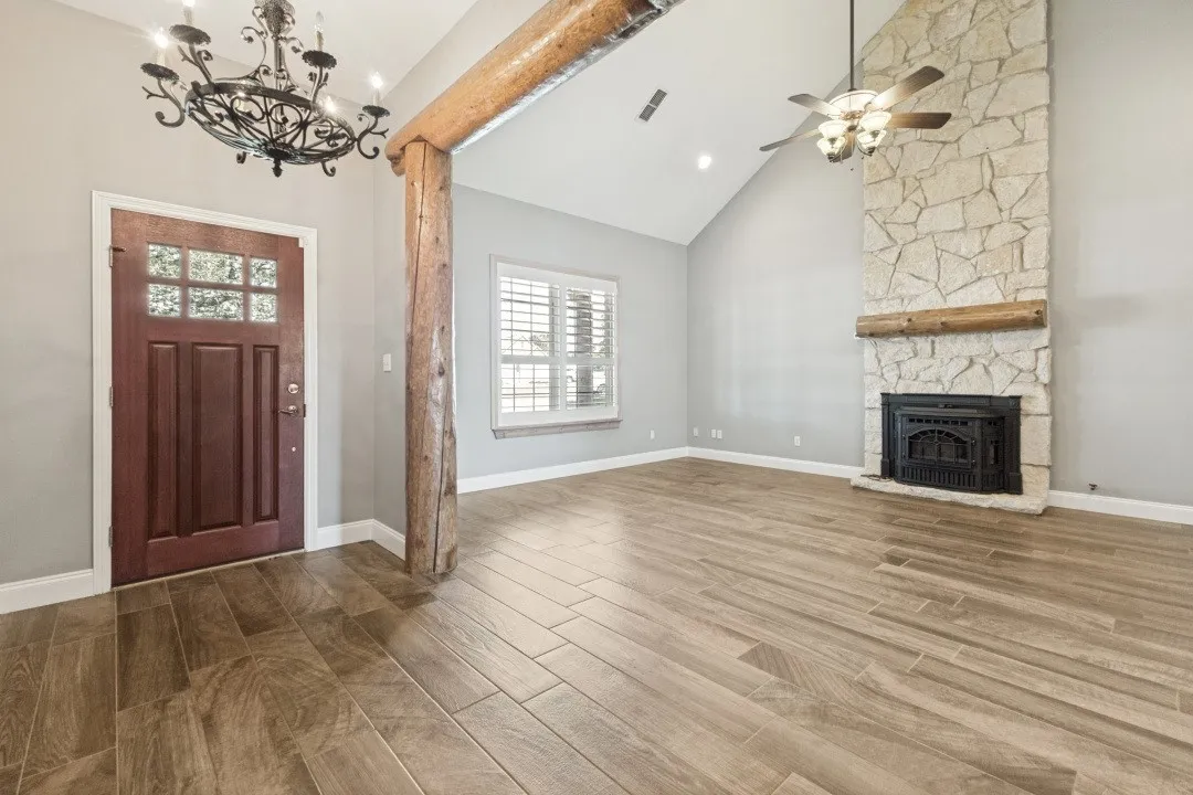 Entry features custom rustic log accents