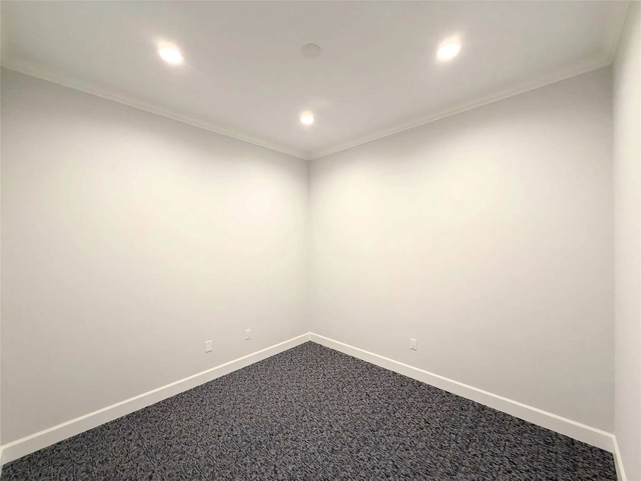 Neutral-toned walls featuring white crown molding and baseboards