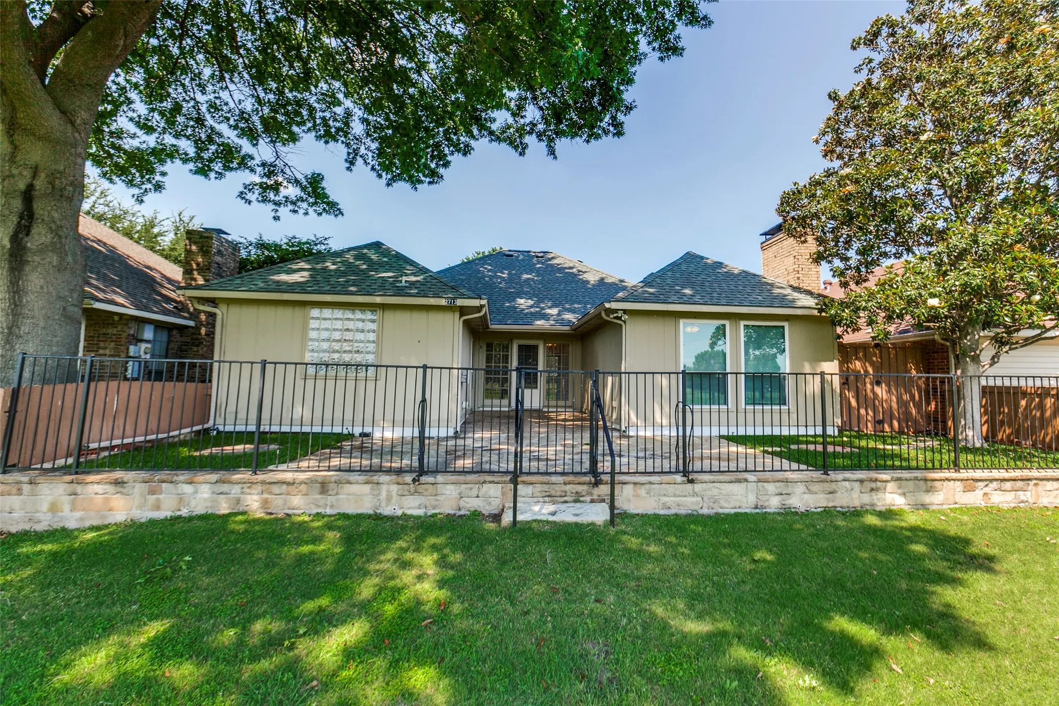 Spacious patio and yard overlooking Greenbelt with views of Duck Creek Golf Club and Duck Creek