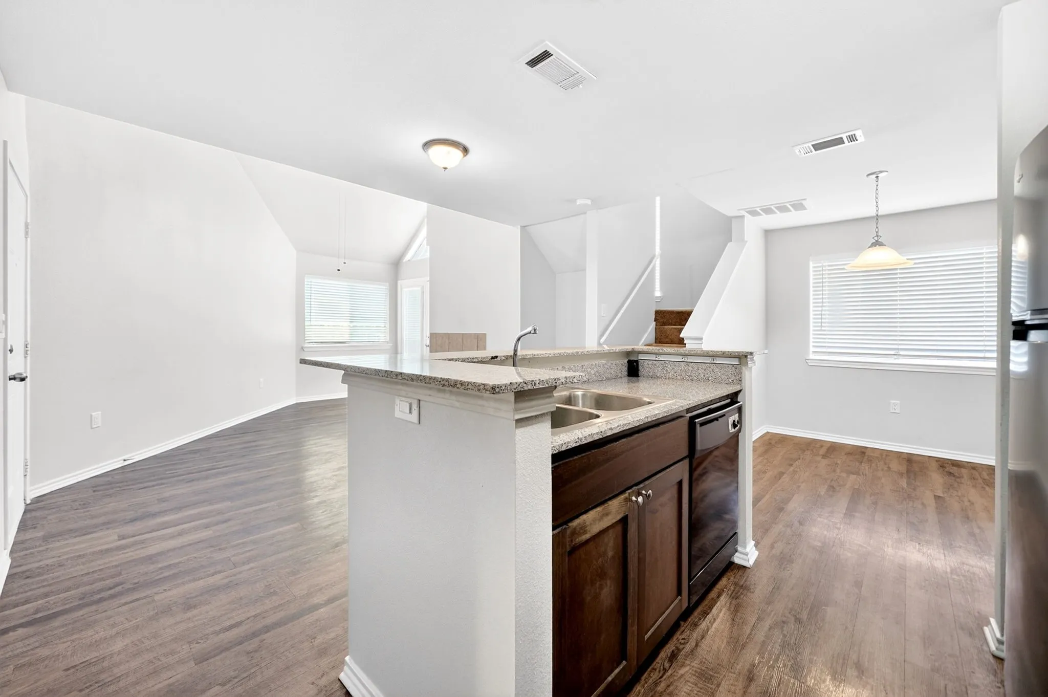 Kitchen island with a double basin sink and a stone-finish countertop