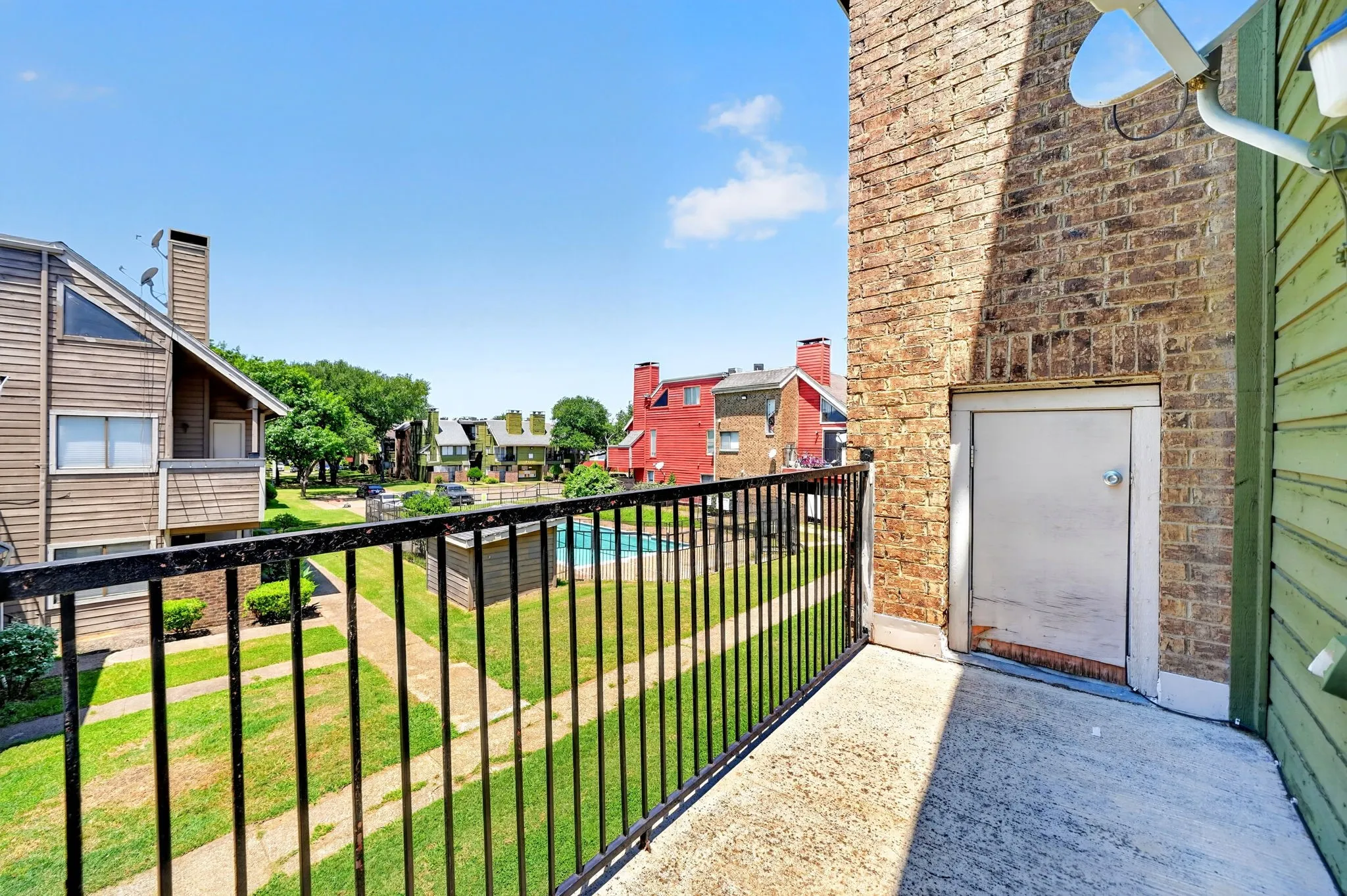 Private balcony with concrete flooring and black metal railings