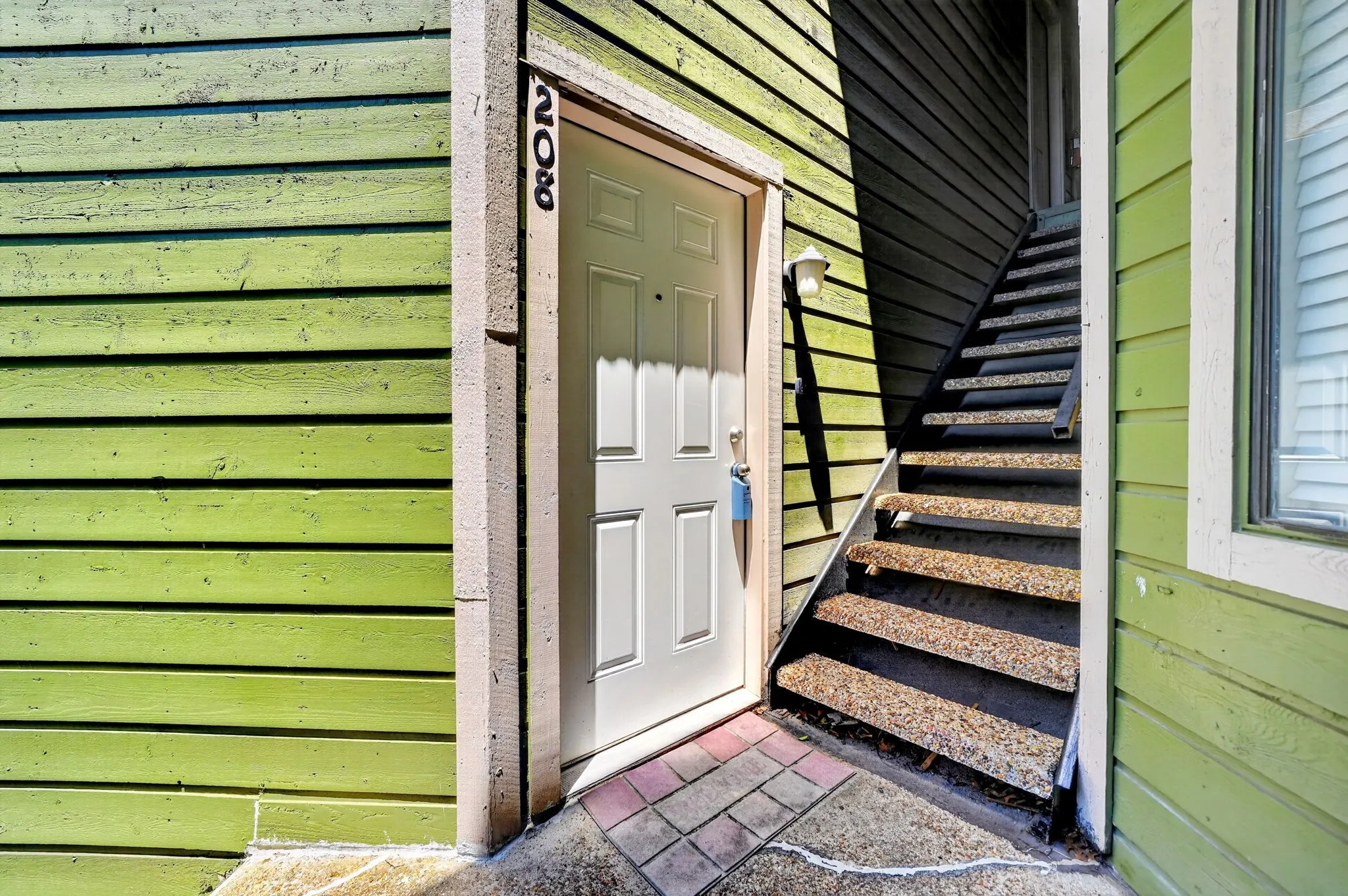 Entry door with light green siding