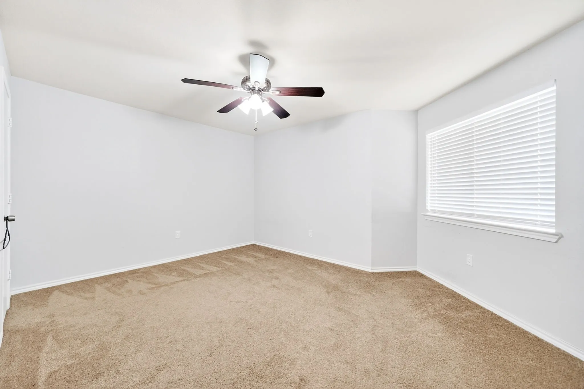 Interior room featuring light-colored walls and tan carpeting
