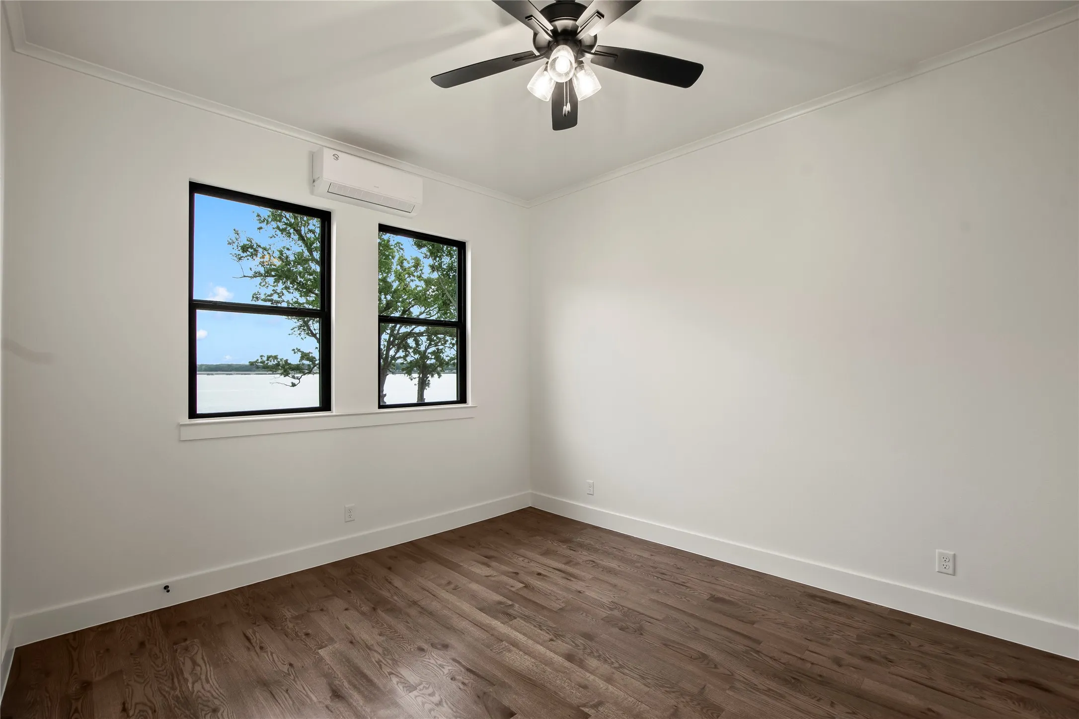 Guest Quarters Bedroom with waterviews, wood floors, and walk in closet.