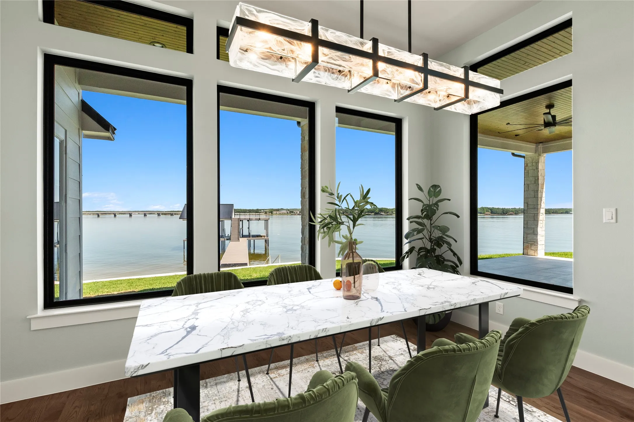 Virtually Staged- Lakeside dining with expansive windows overlooking the water.