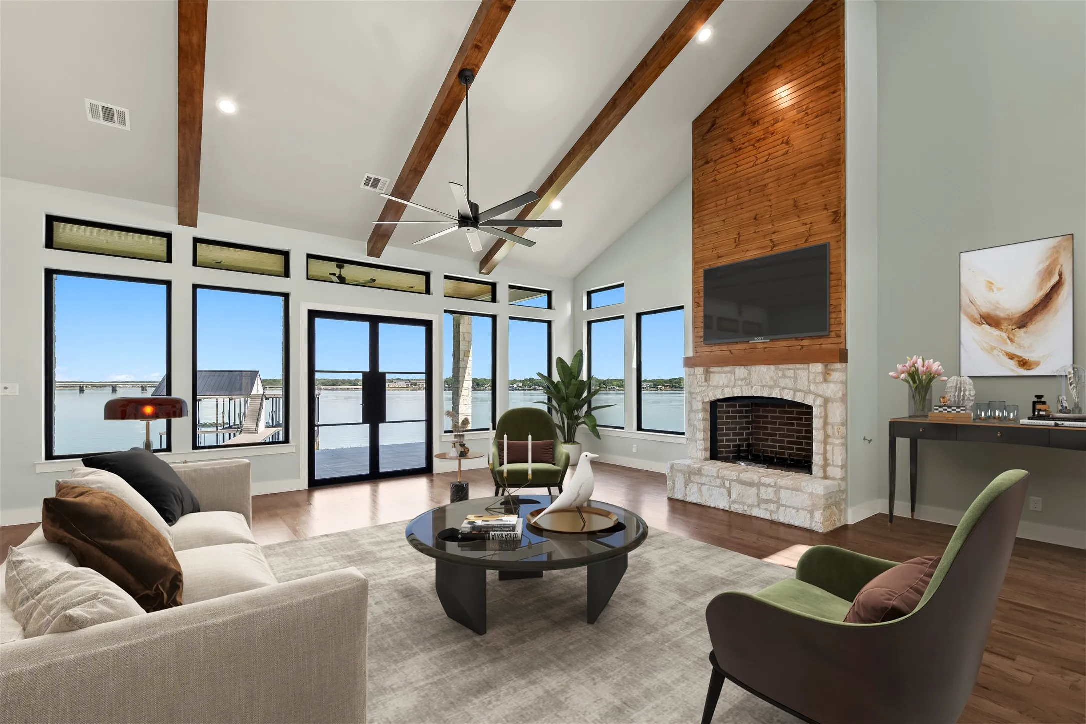 Virtually Staged-Stunning stone wood-burning fireplace. Natural light pours through expansive lakeside windows.