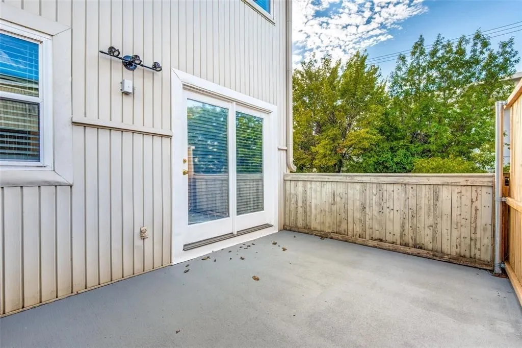 Outdoor patio featuring a concrete surface and a wooden privacy fence