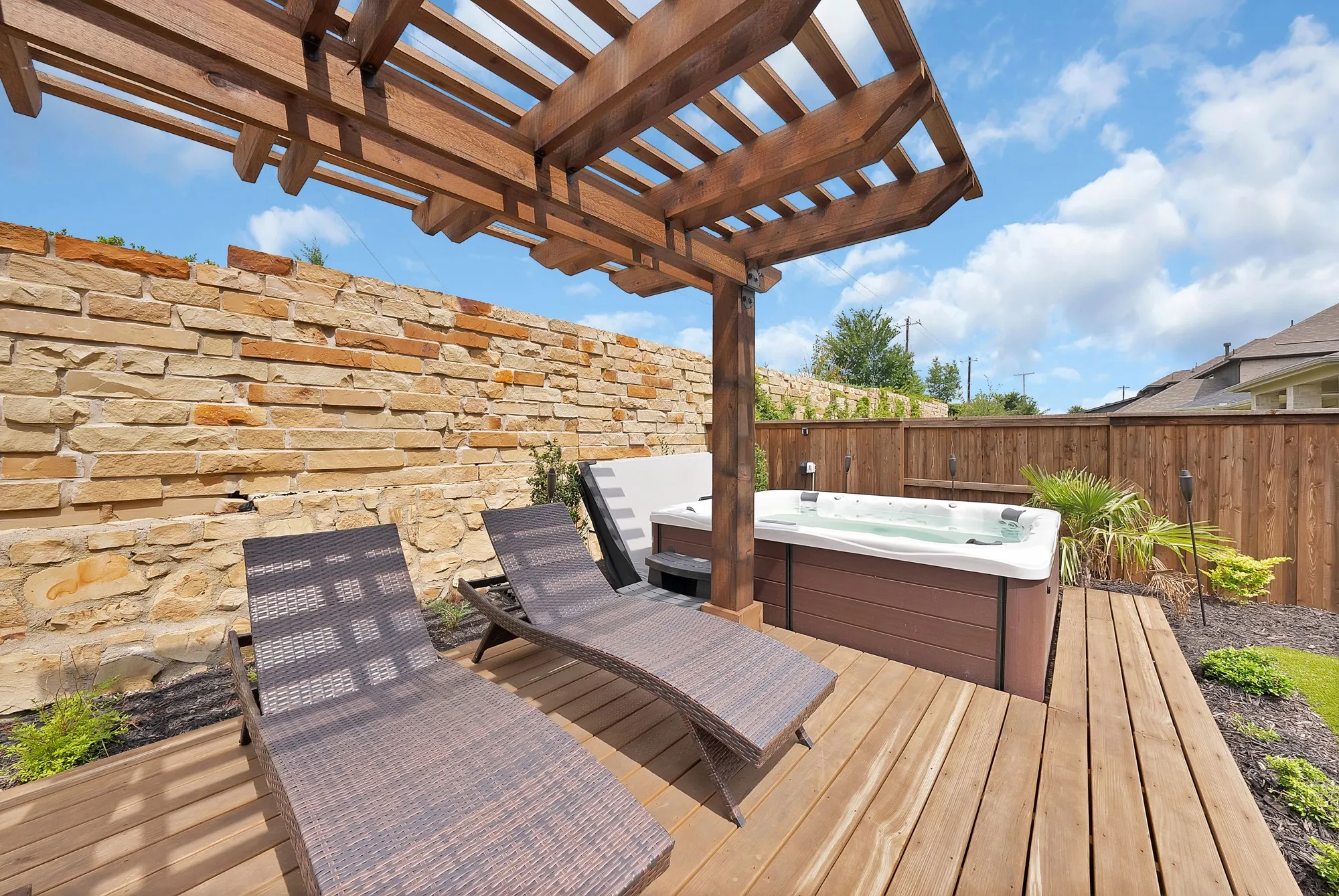 Wooden pergola and sun deck with a relaxing spa.