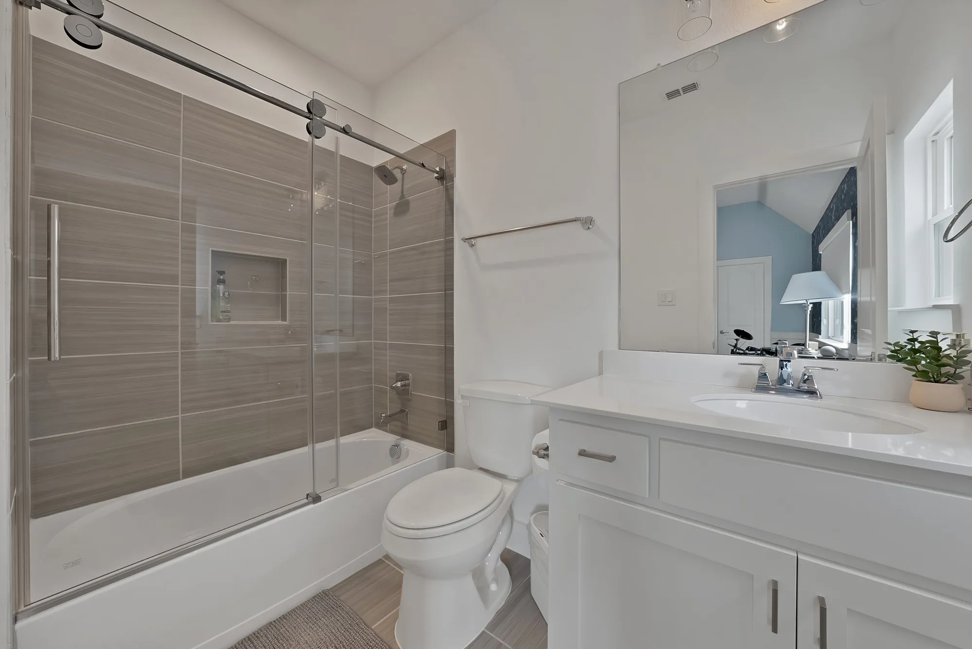 En-suite bathroom with barn door style glass doors.