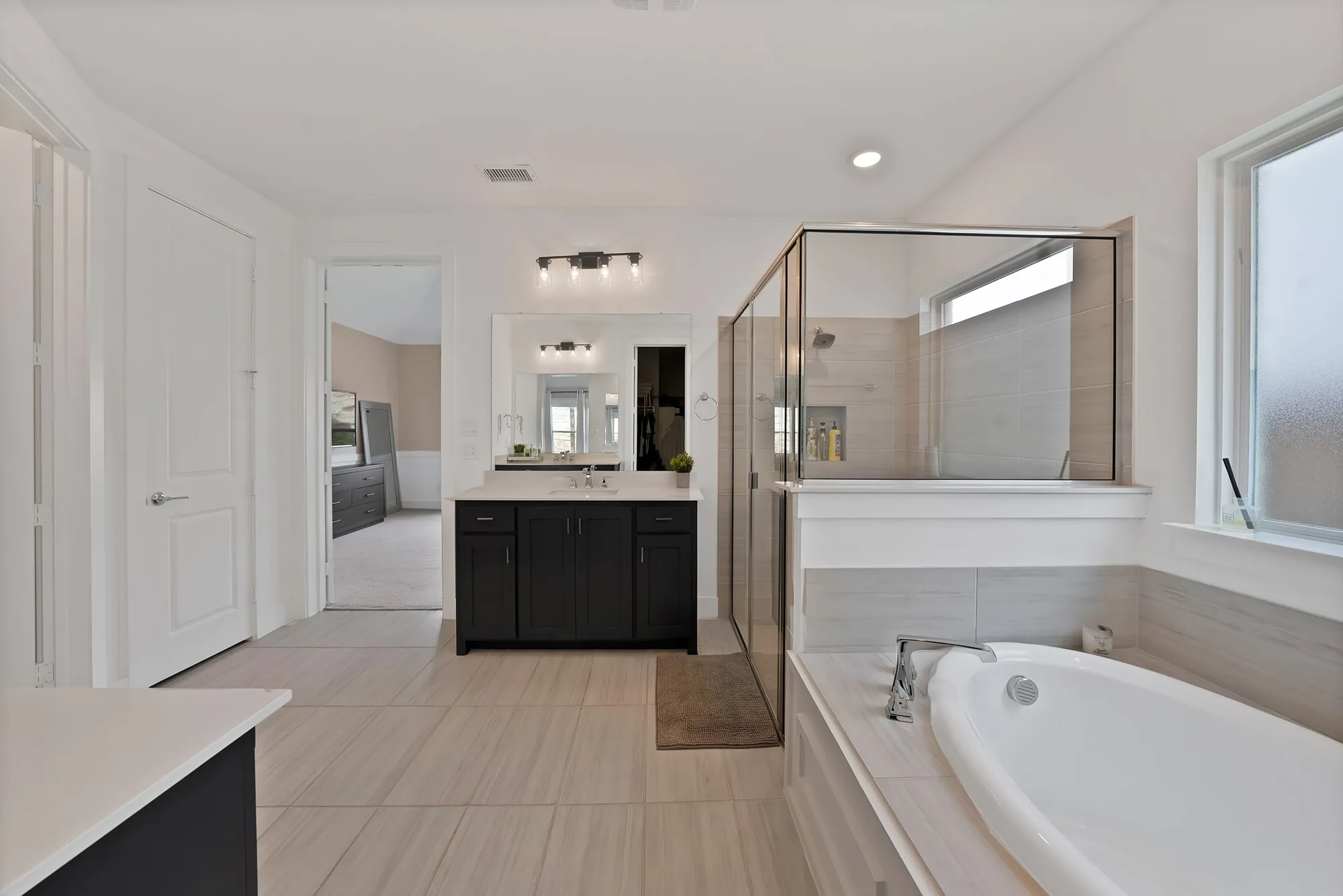 Spa-inspired primary bathroom is thoughtfully designed for relaxation and rejuvenation.