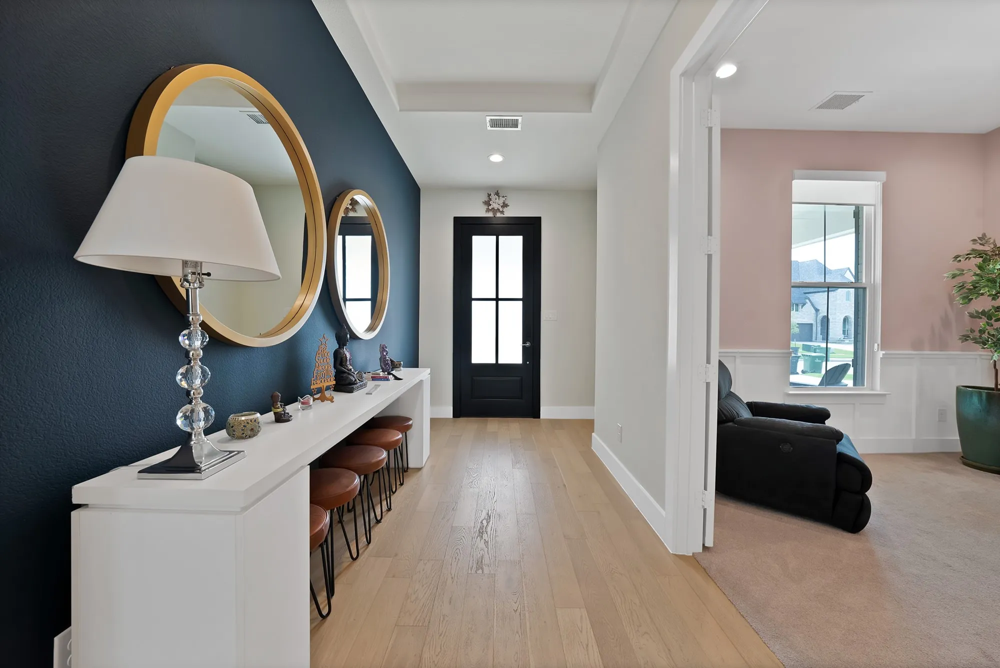 Inviting entry with attractive flooring that extends throughout the main areas of the home downstairs.
