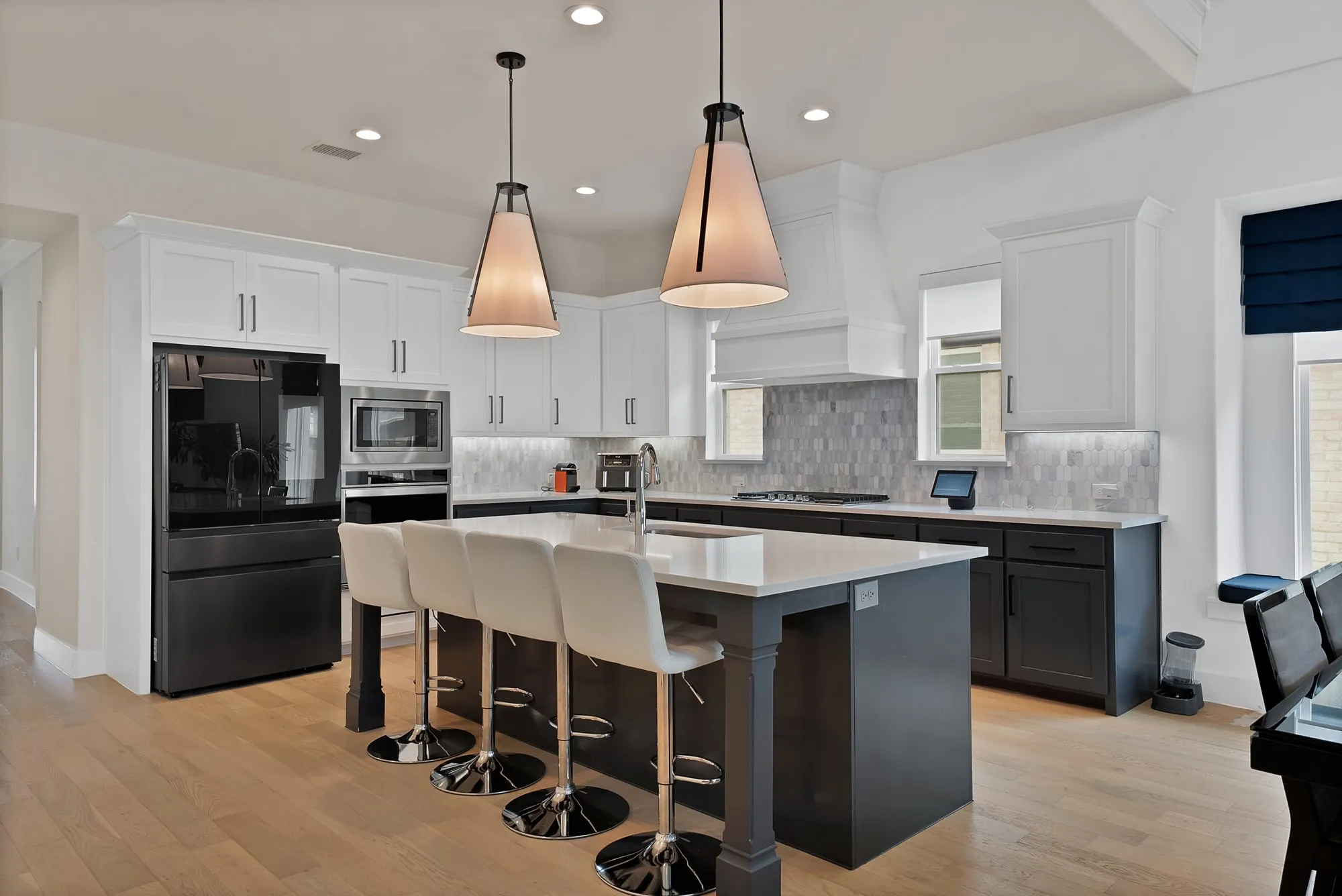 This stunning kitchen features modern appliances, sleek countertops and an abundance of cabinetry.