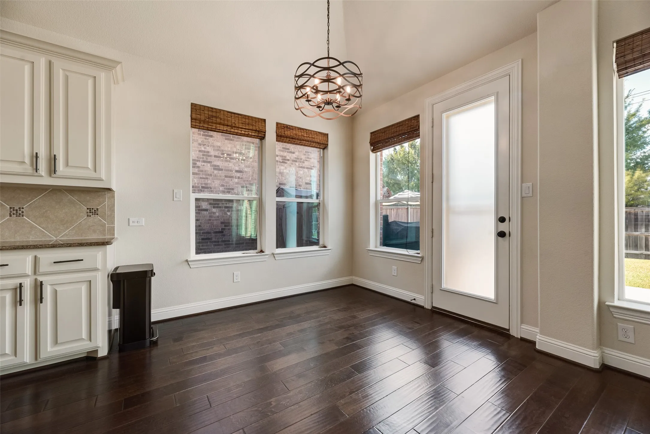 Breakfast Nook featuring designer light fixture and rolling shades.