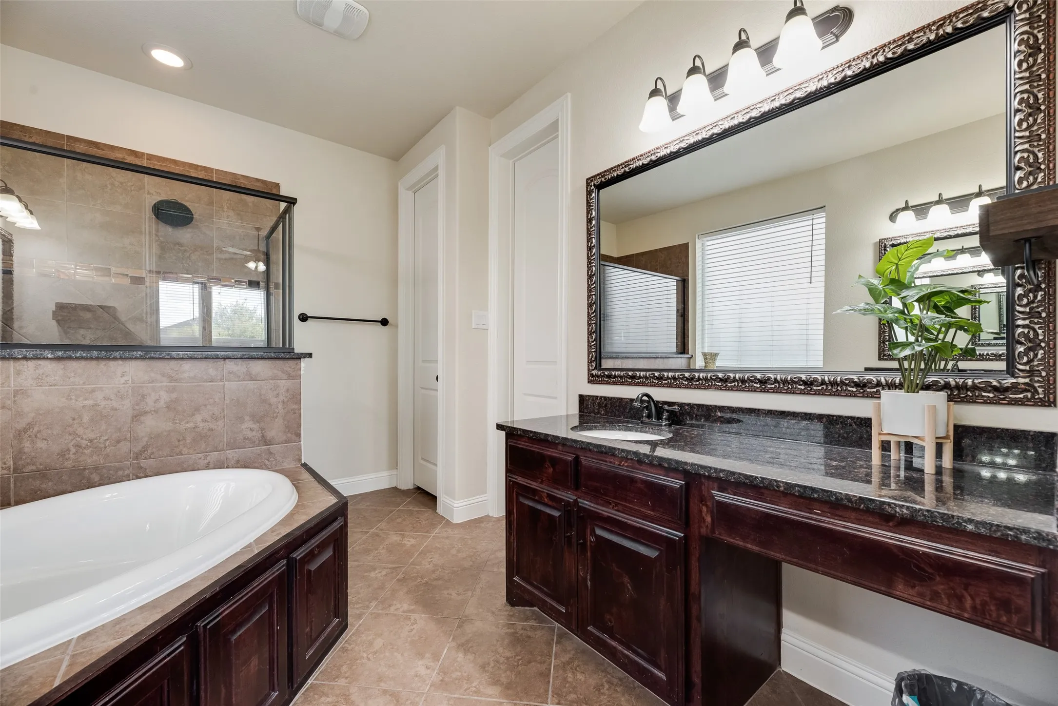 View of Master Bathroom with nice soaking tub and large vanity.  Two total vanities in room
