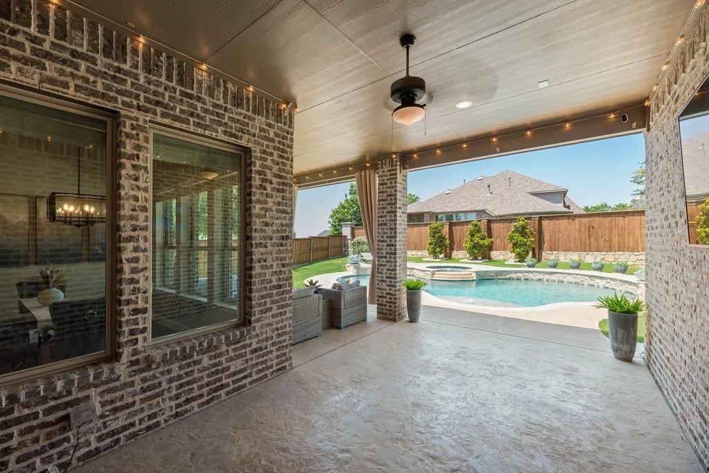 Covered patio featuring a ceiling fan, recessed lighting, and stamped concrete flooring