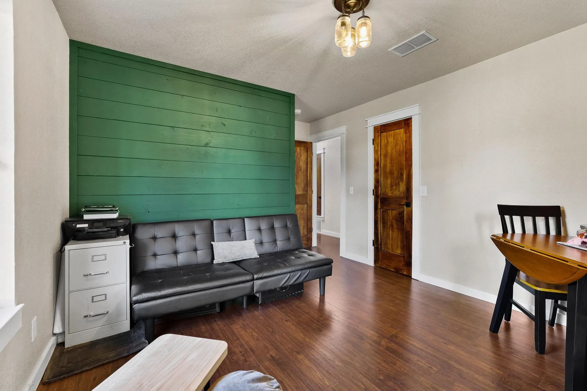 Accent wall featuring horizontal wood paneling in a vibrant green finish