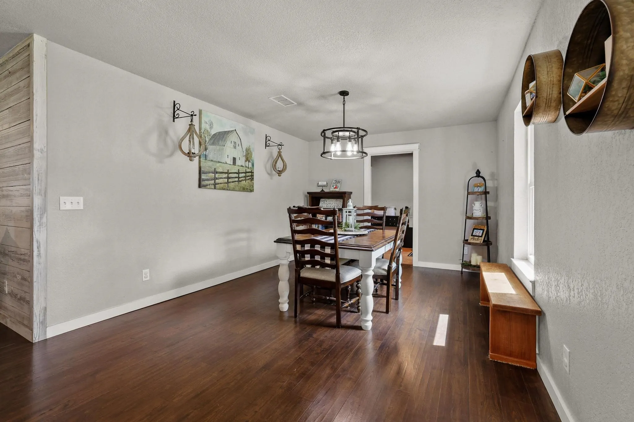 Wood-finish flooring throughout, complemented by light-toned wall paint and white trim