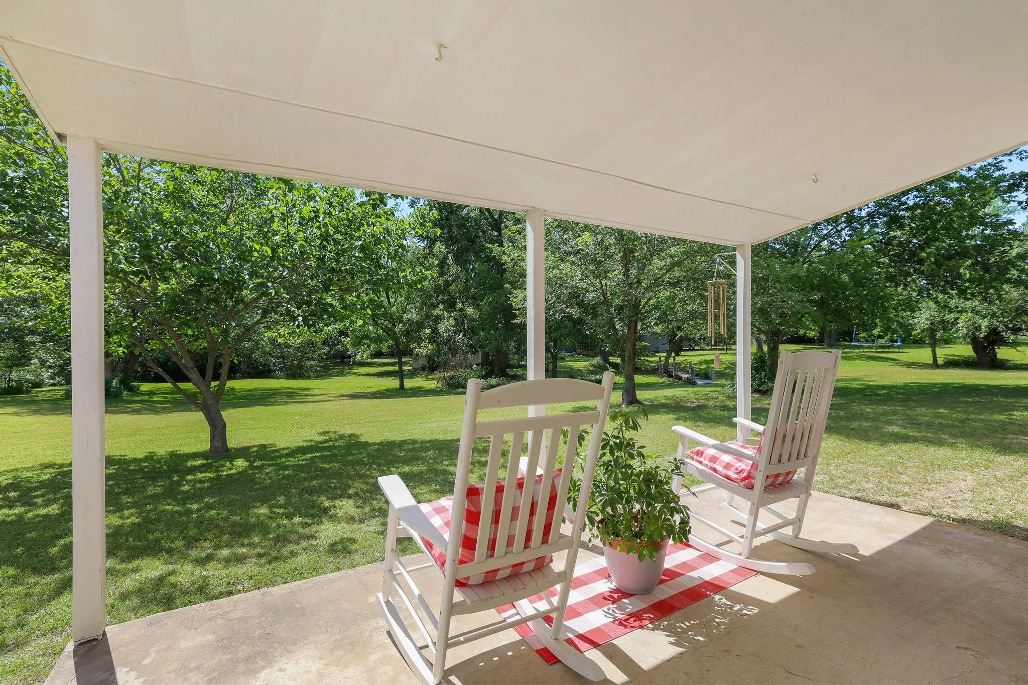 Covered porch with a concrete patio surface