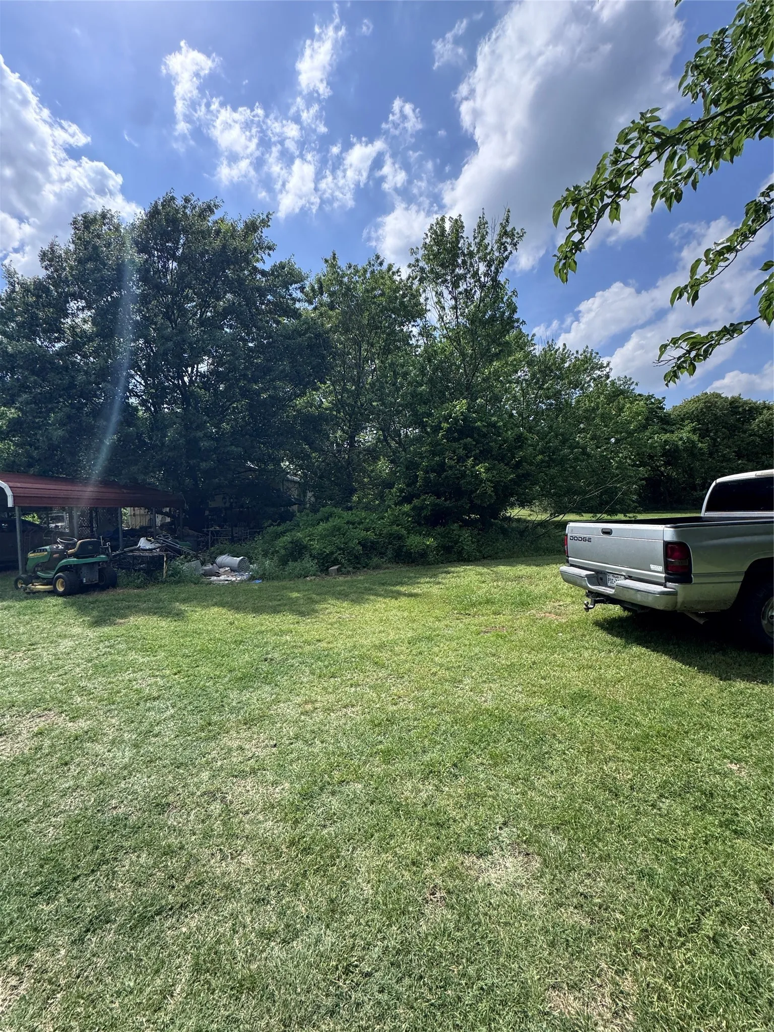Expansive grassy yard with mature trees