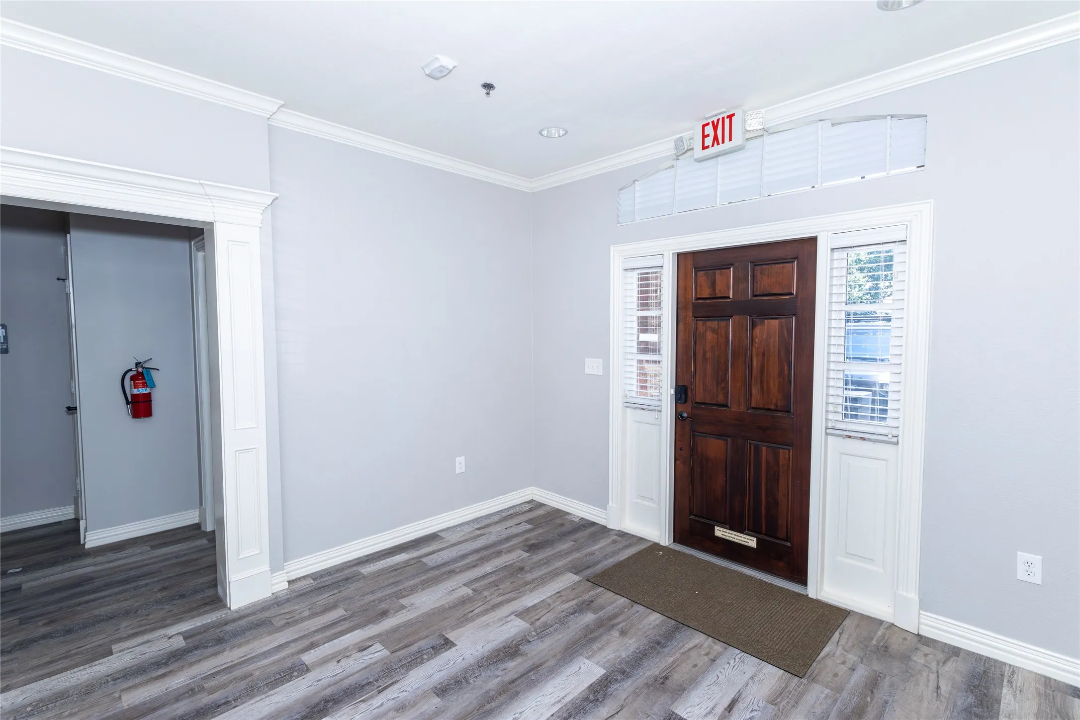 Entrance foyer featuring ornamental molding and wood finished floors