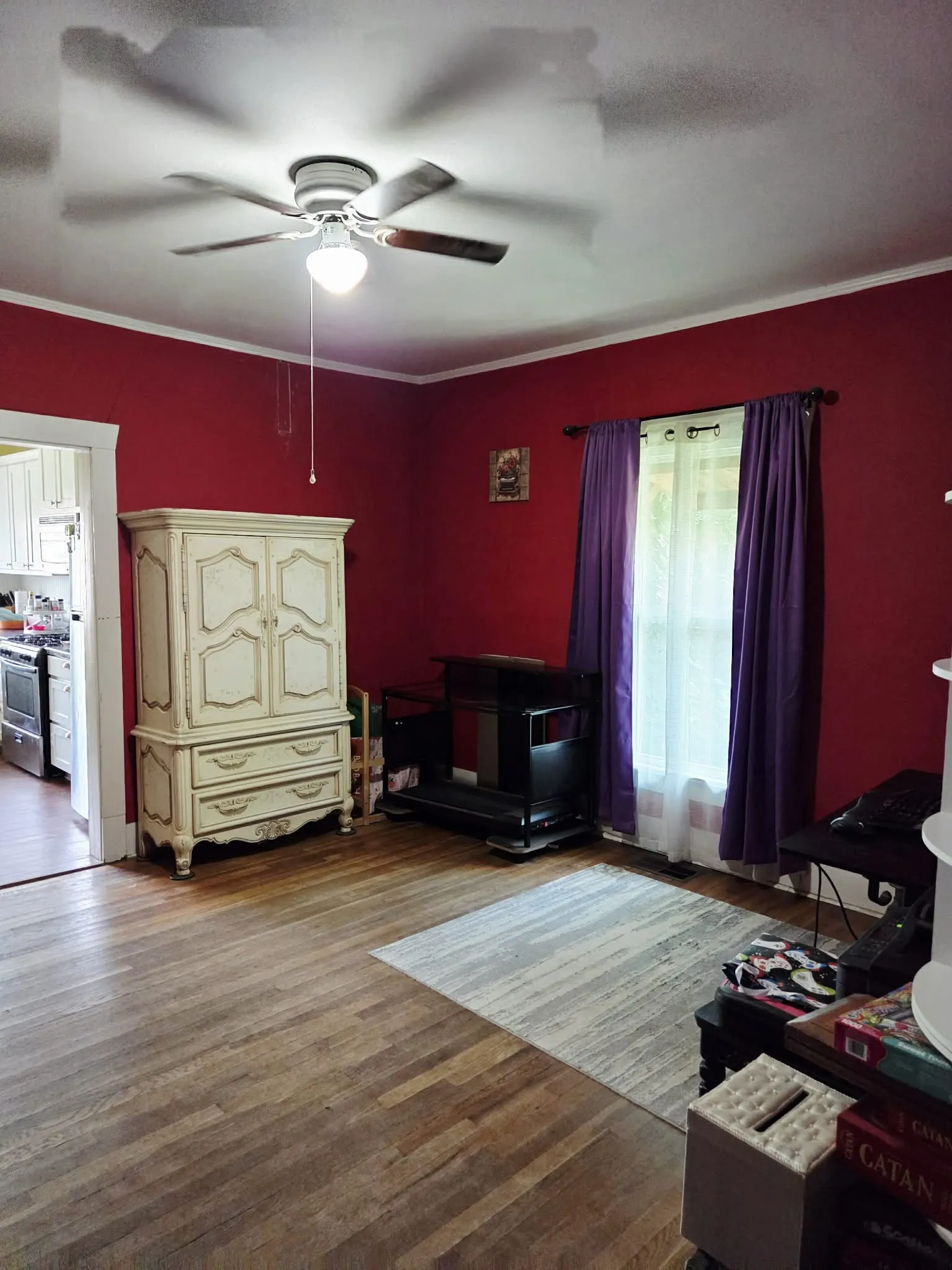 Hardwood-finish flooring throughout, featuring a ceiling fan with integrated lighting