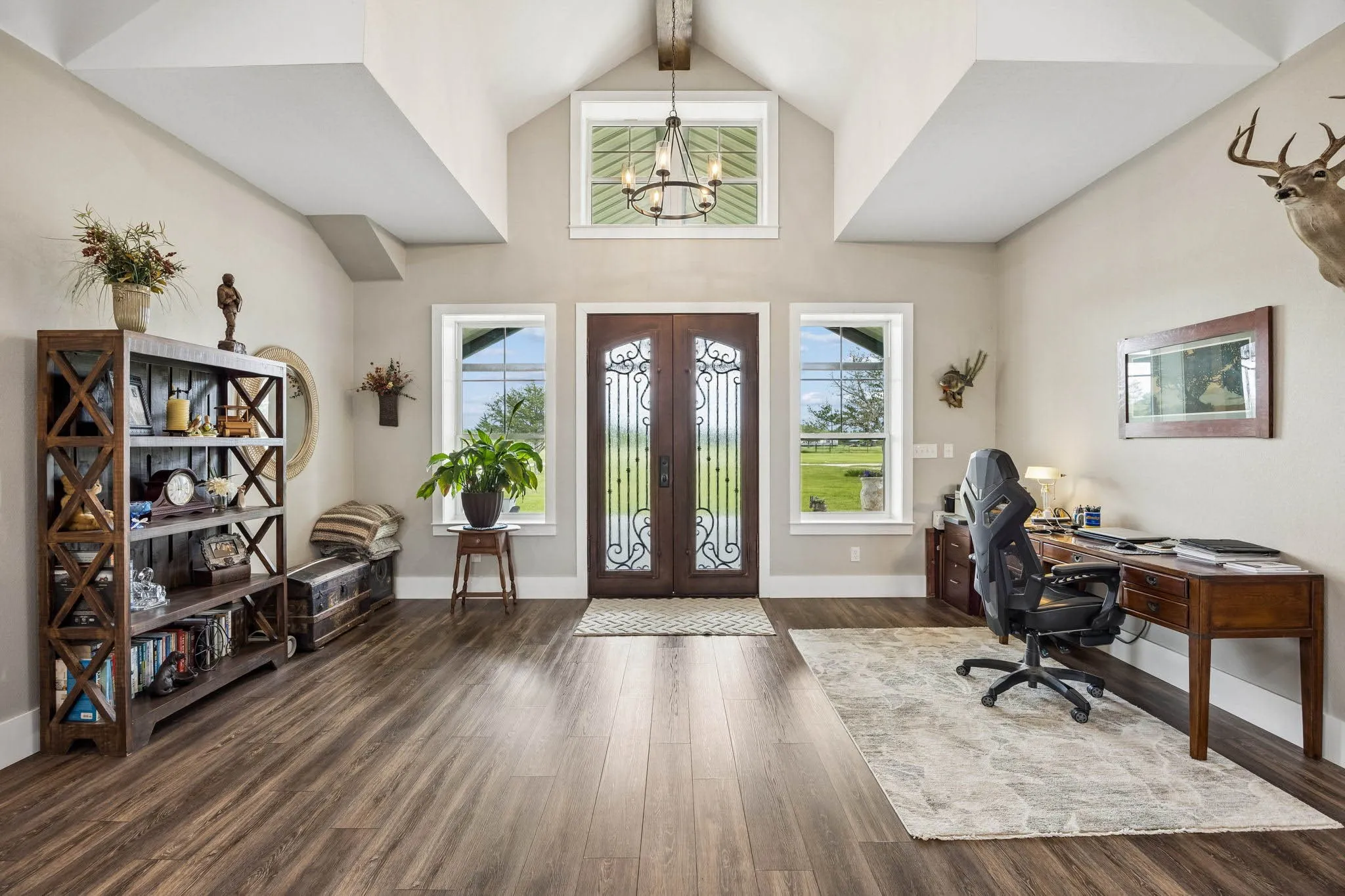 Grand entry foyer featuring a vaulted ceiling and wood-finish flooring