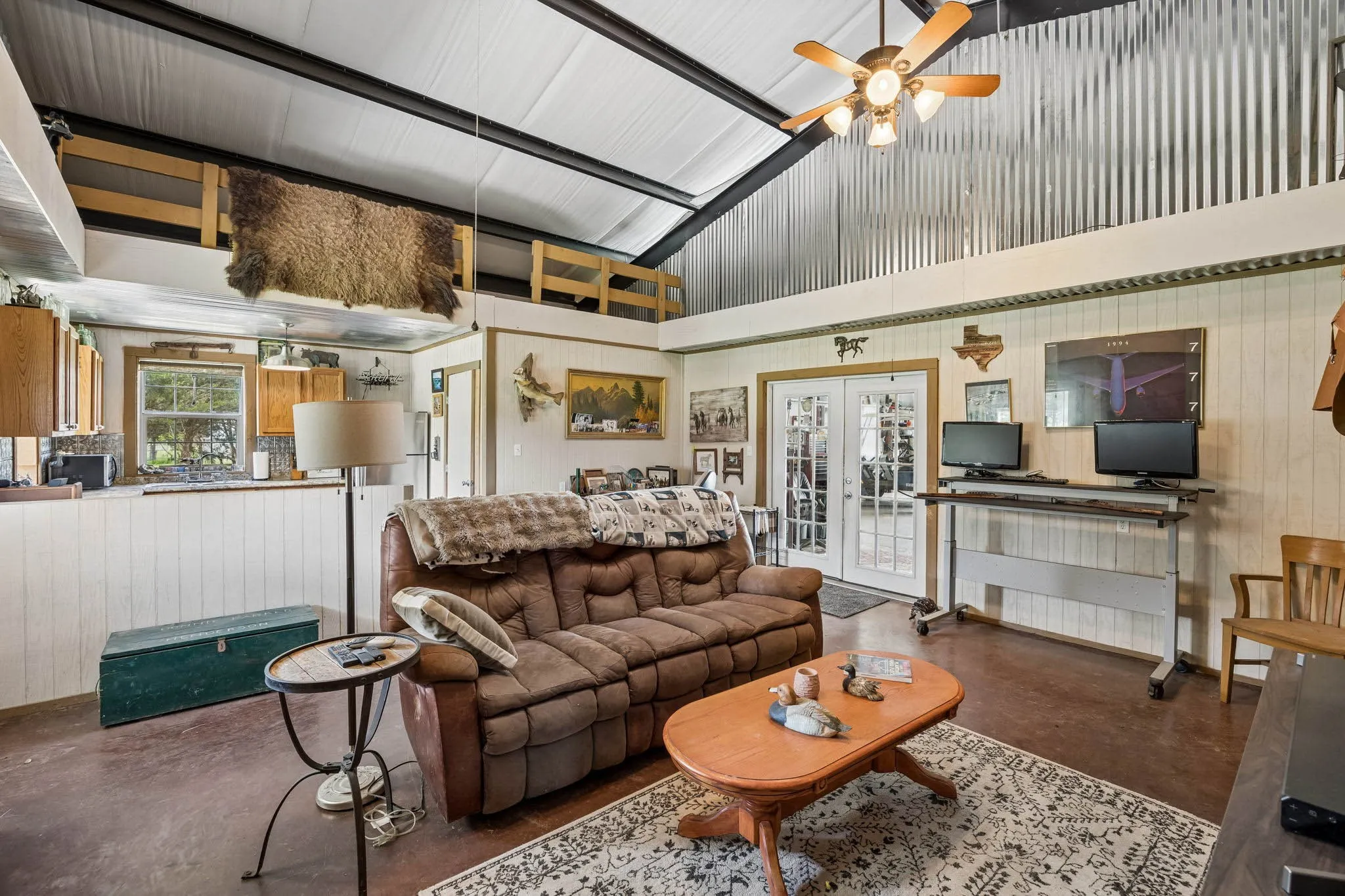 Vaulted ceiling with exposed beams and corrugated metal accents