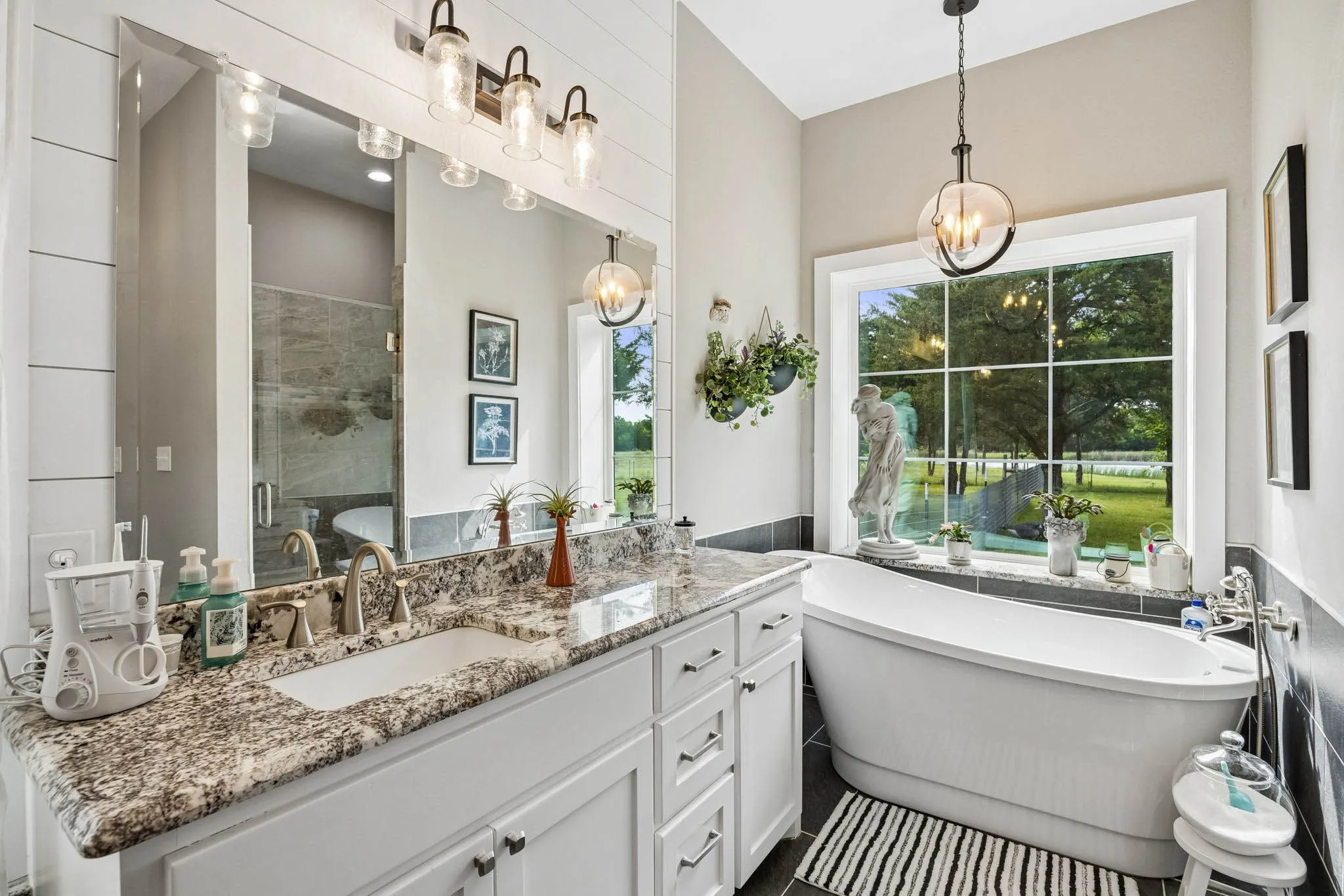 Freestanding soaking tub positioned before a large window