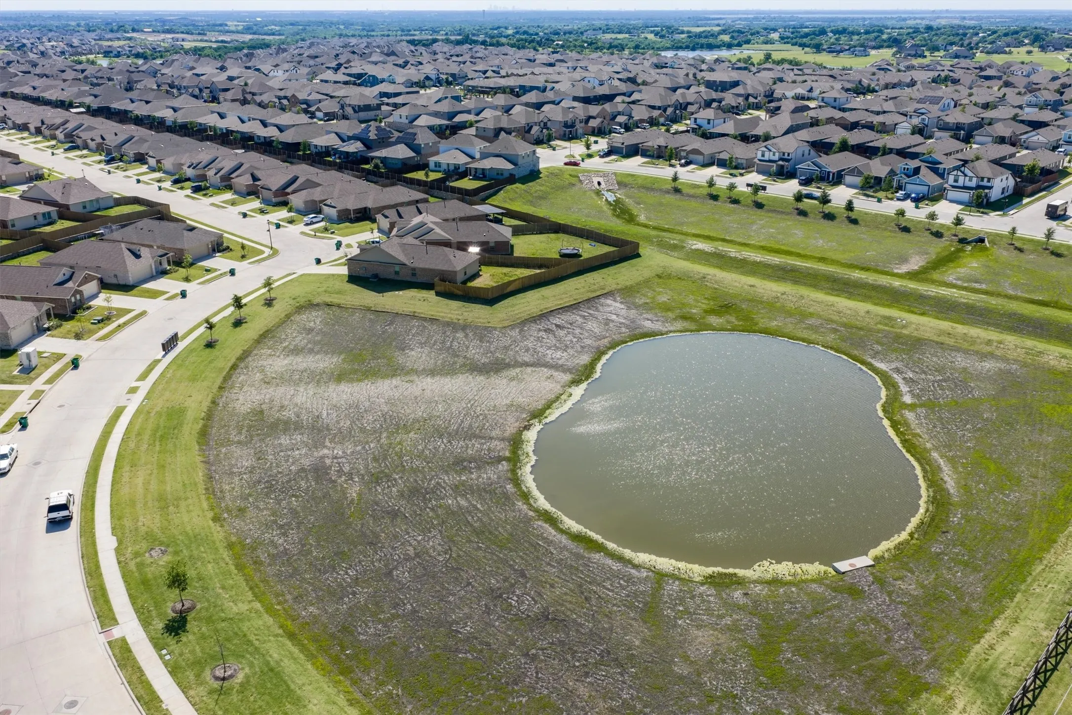 Neighborhood featuring a pond, paved streets, sidewalks, and numerous single-story residences