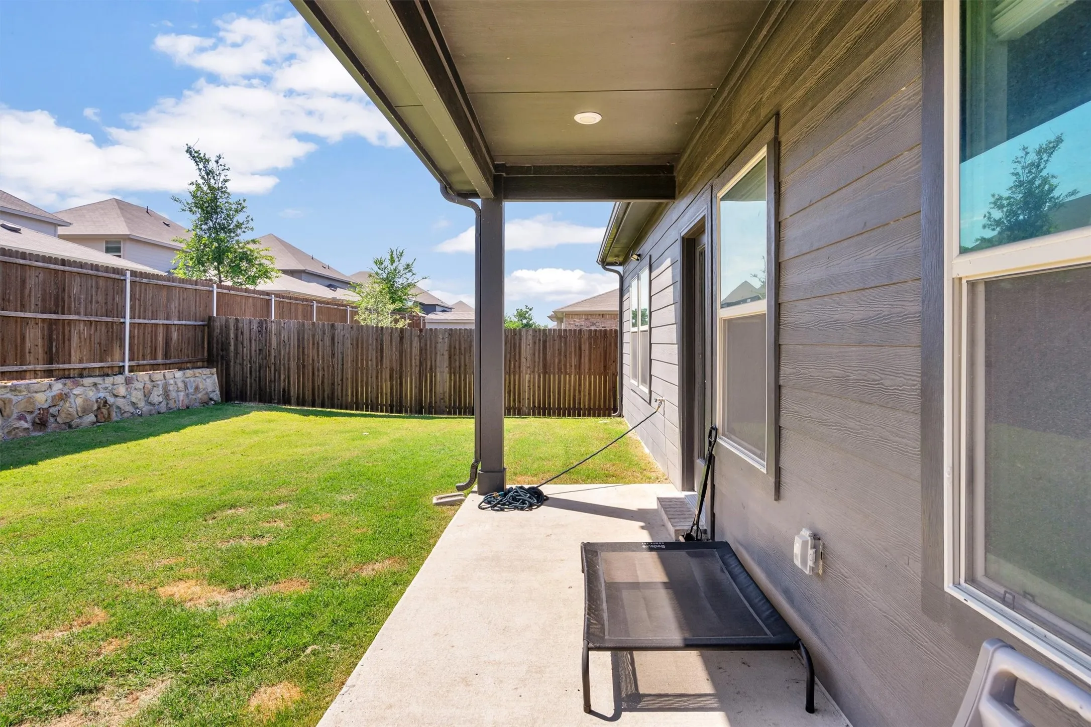 Covered patio featuring a concrete slab and painted siding