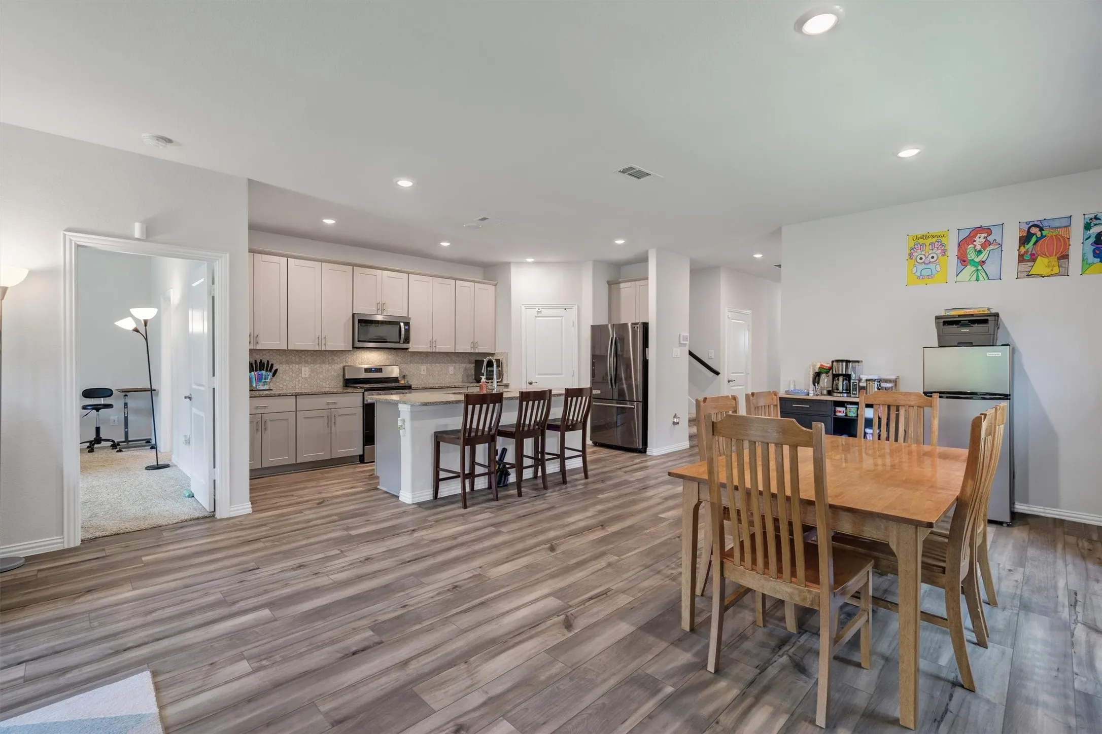 Open-concept kitchen and dining area featuring wood-finish flooring