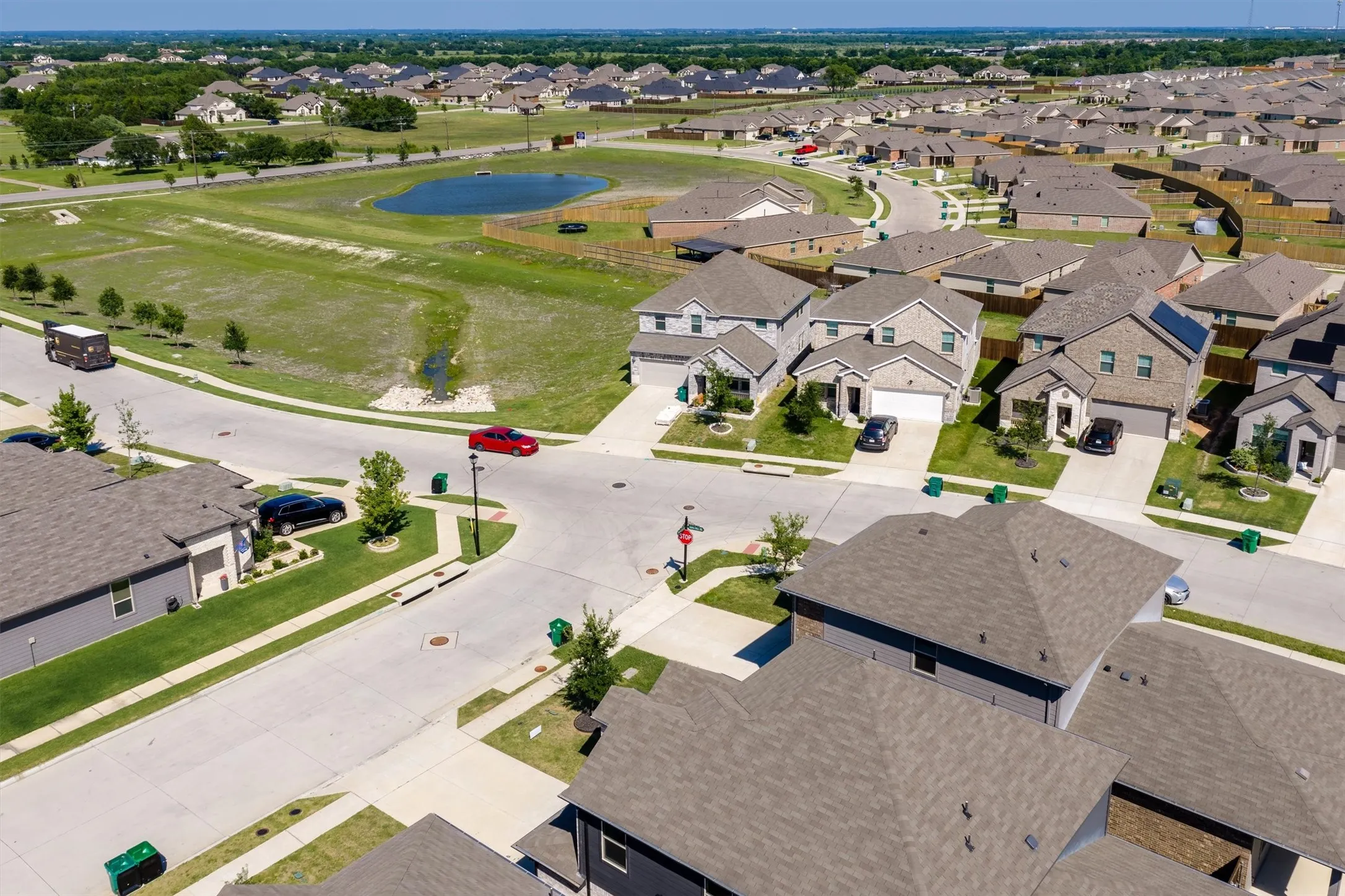 Residential development featuring uniform asphalt shingle roofs and concrete driveways